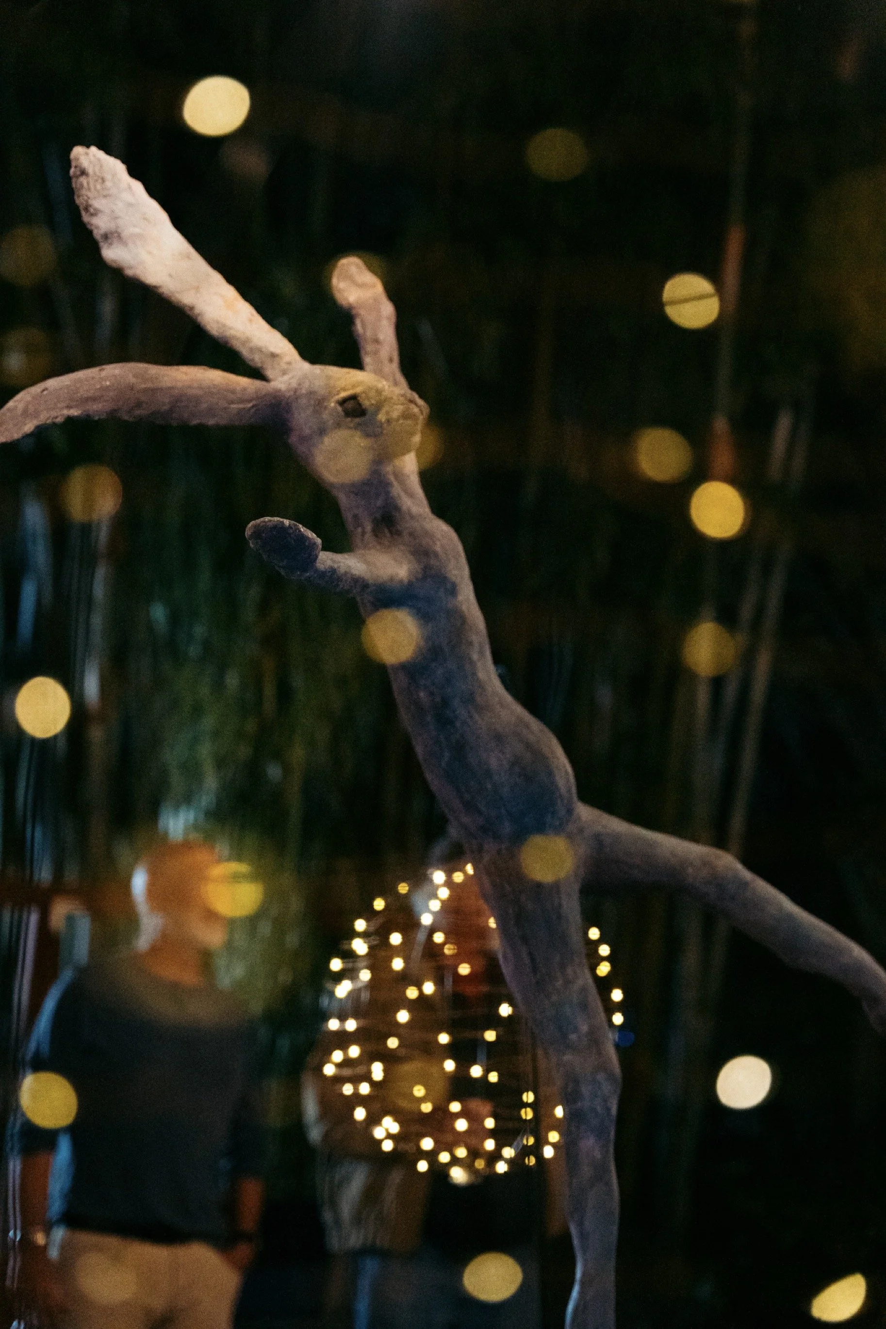 A  dancing hare is illuminated in a garden where musical events are often staged.