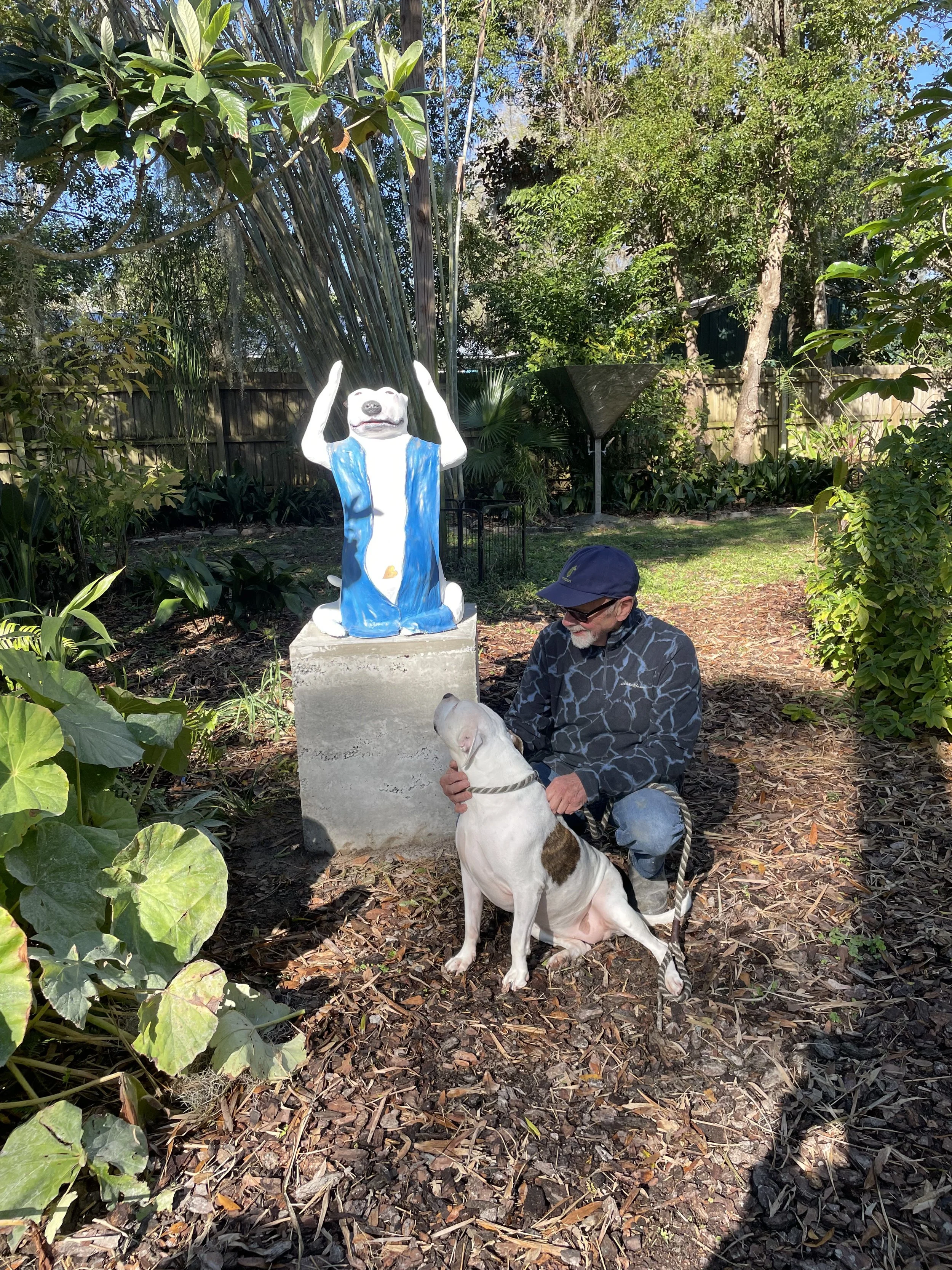 The artist and his muse, 'Jellybean,' in the garden next to 'Buddha Dog'.
