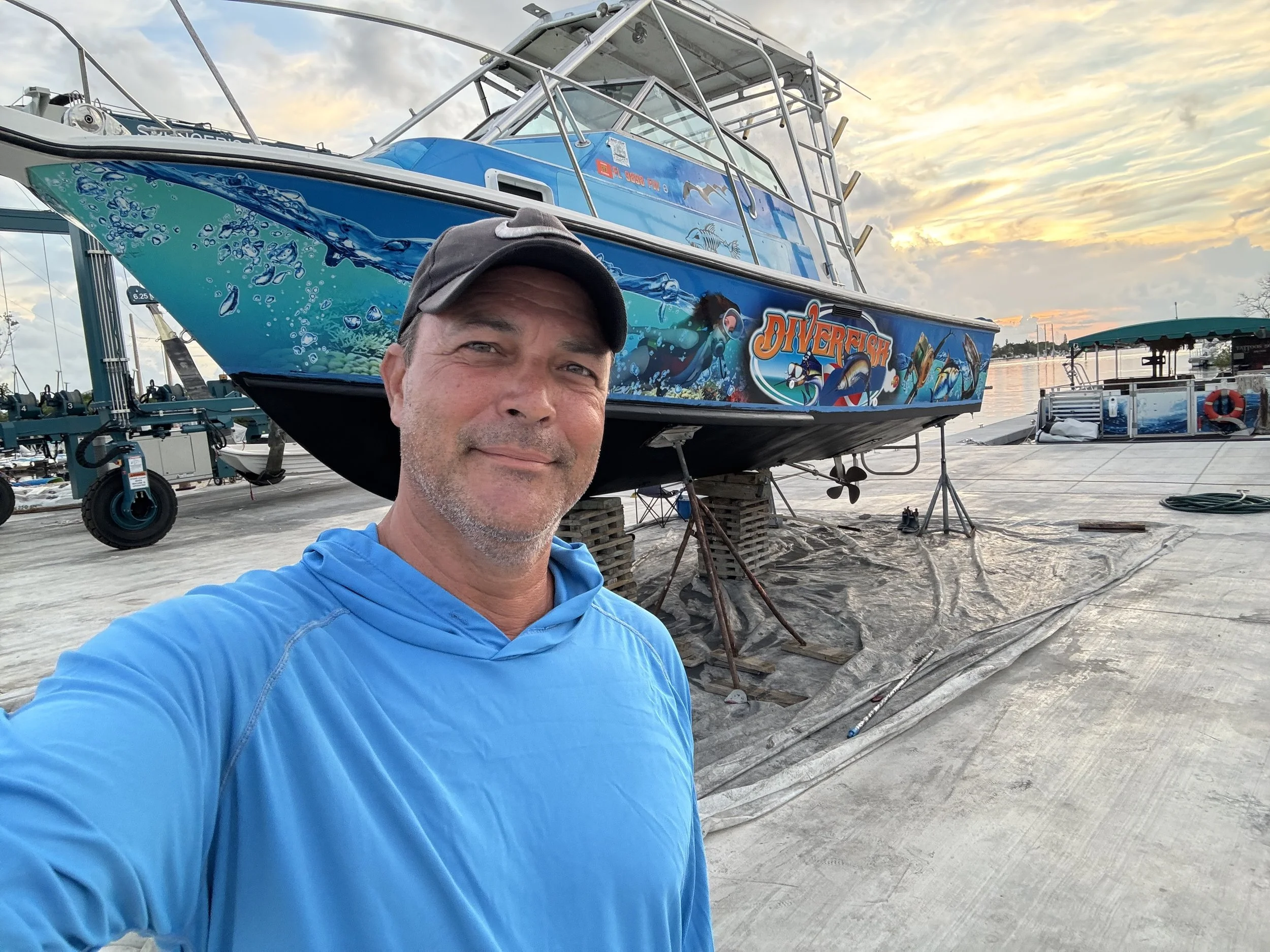 Captain Rod Walline at the dock with a wrapped fishing boat at sunset