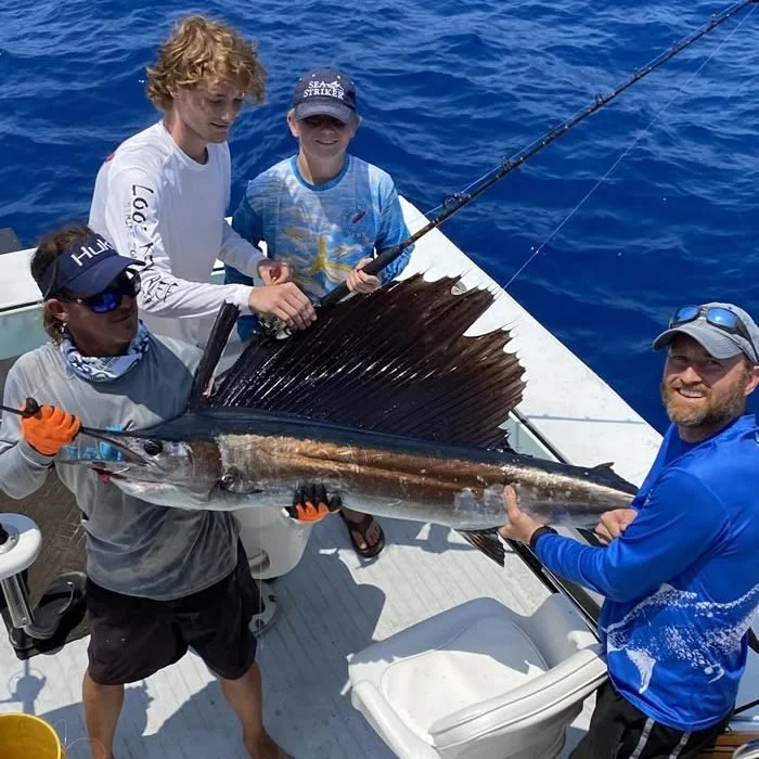 Group of anglers with a sailfish catch on a Cool Breeze charter
