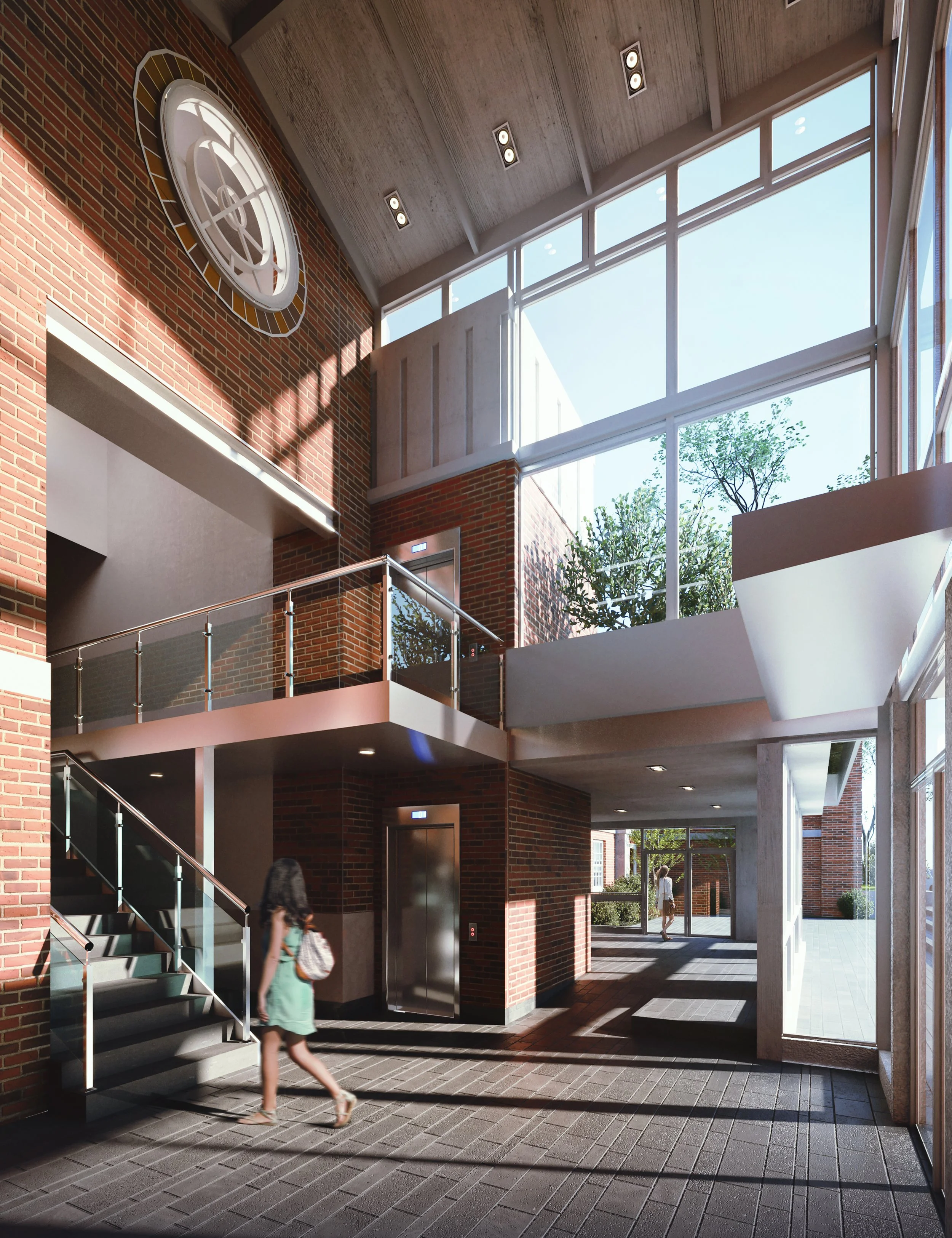 Interior of a modern building with brick walls, large windows, a clock on the wall, a staircase with glass railing, elevator, and people walking inside.