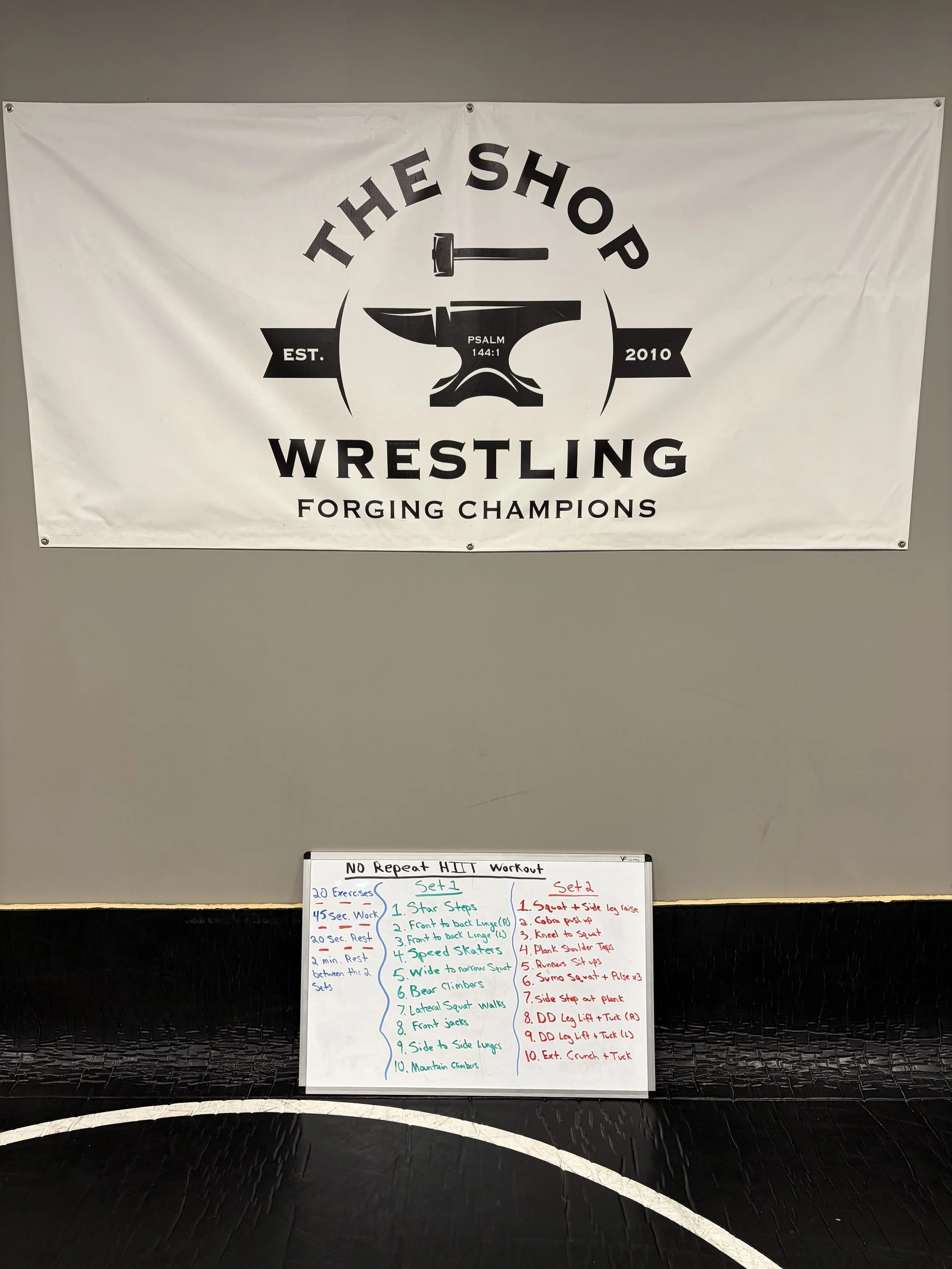 A large banner with a logo featuring a hammer hitting an anvil and a Bible verse, stating