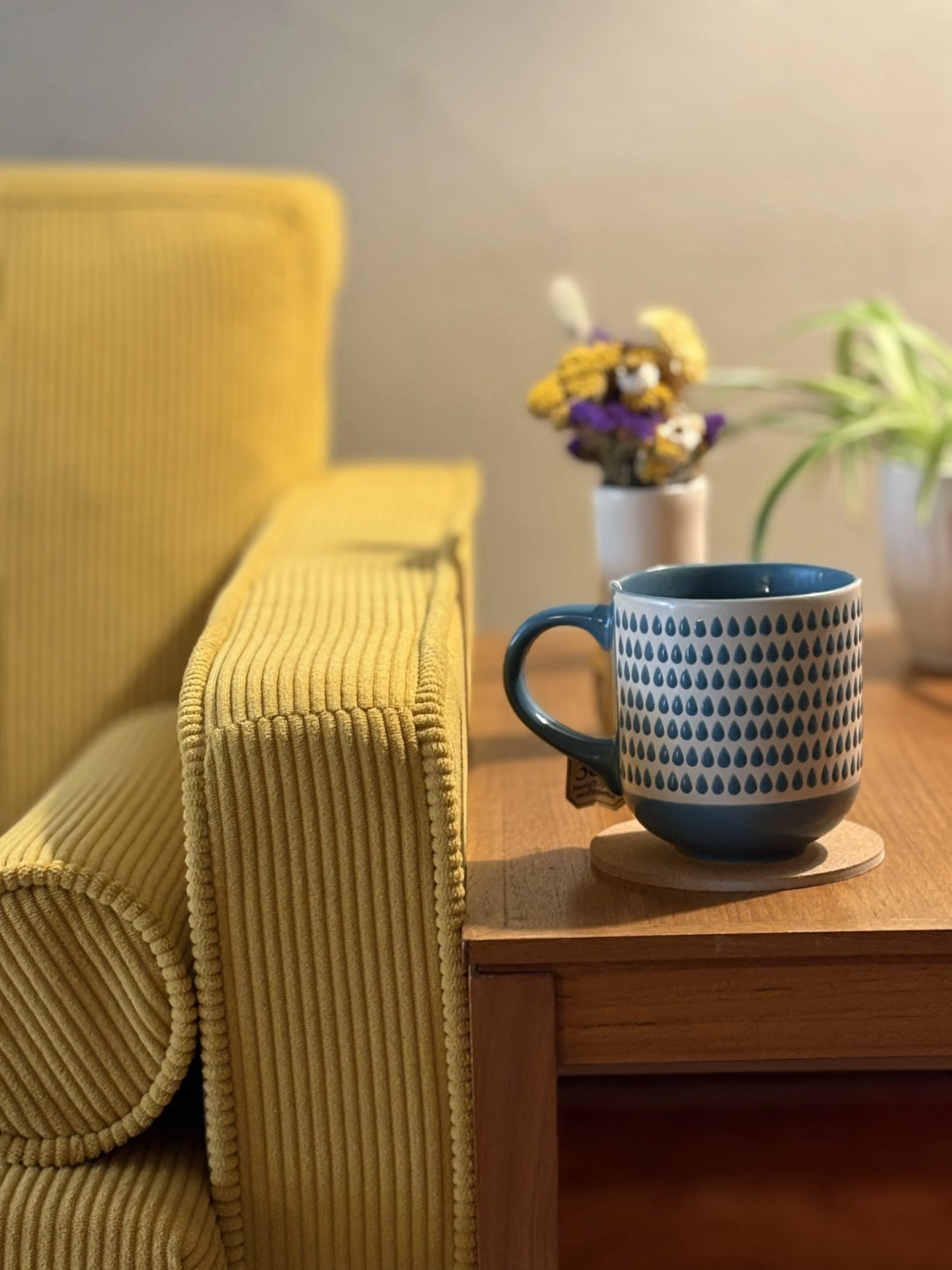 Tea, flowers, and the edge of a therapy couch in a counselling office in Nelson, BC