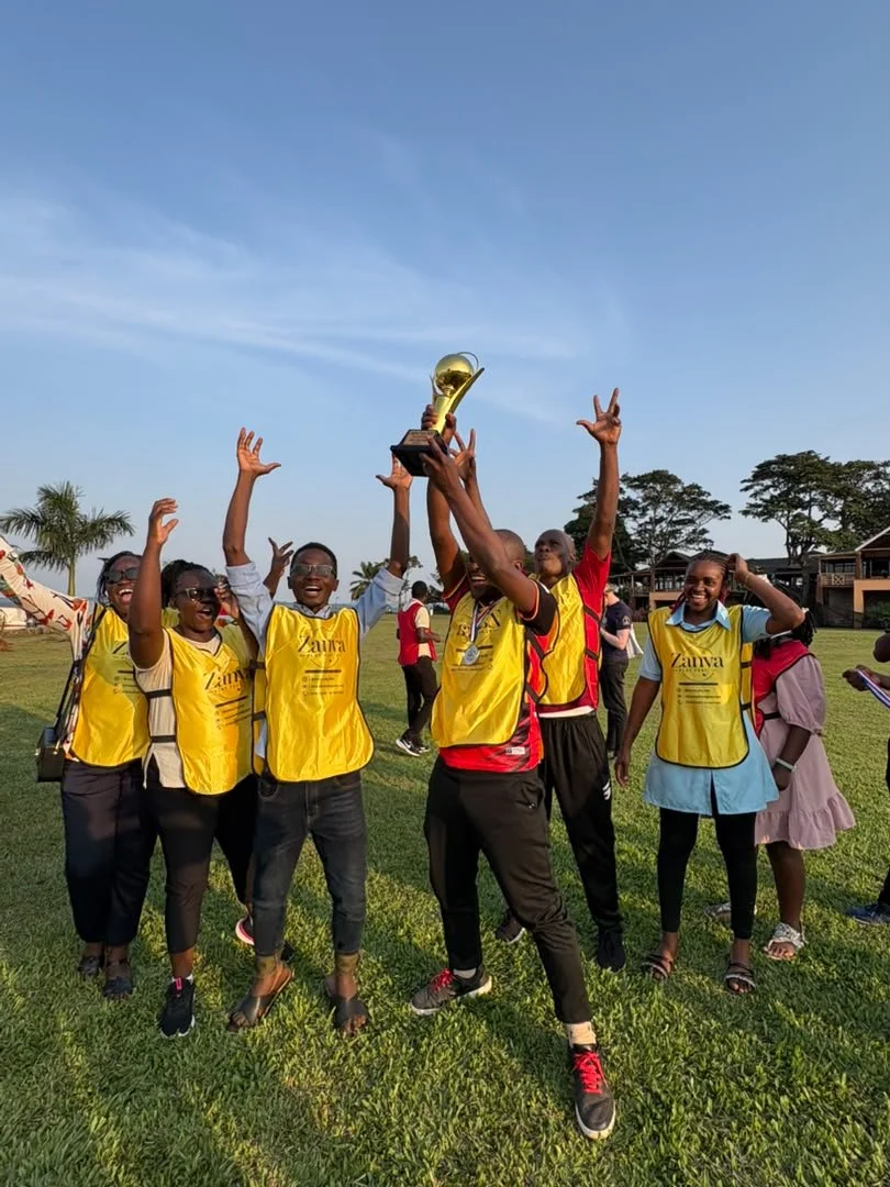Zanya Play Fest participants raise a trophy and celebrate together.