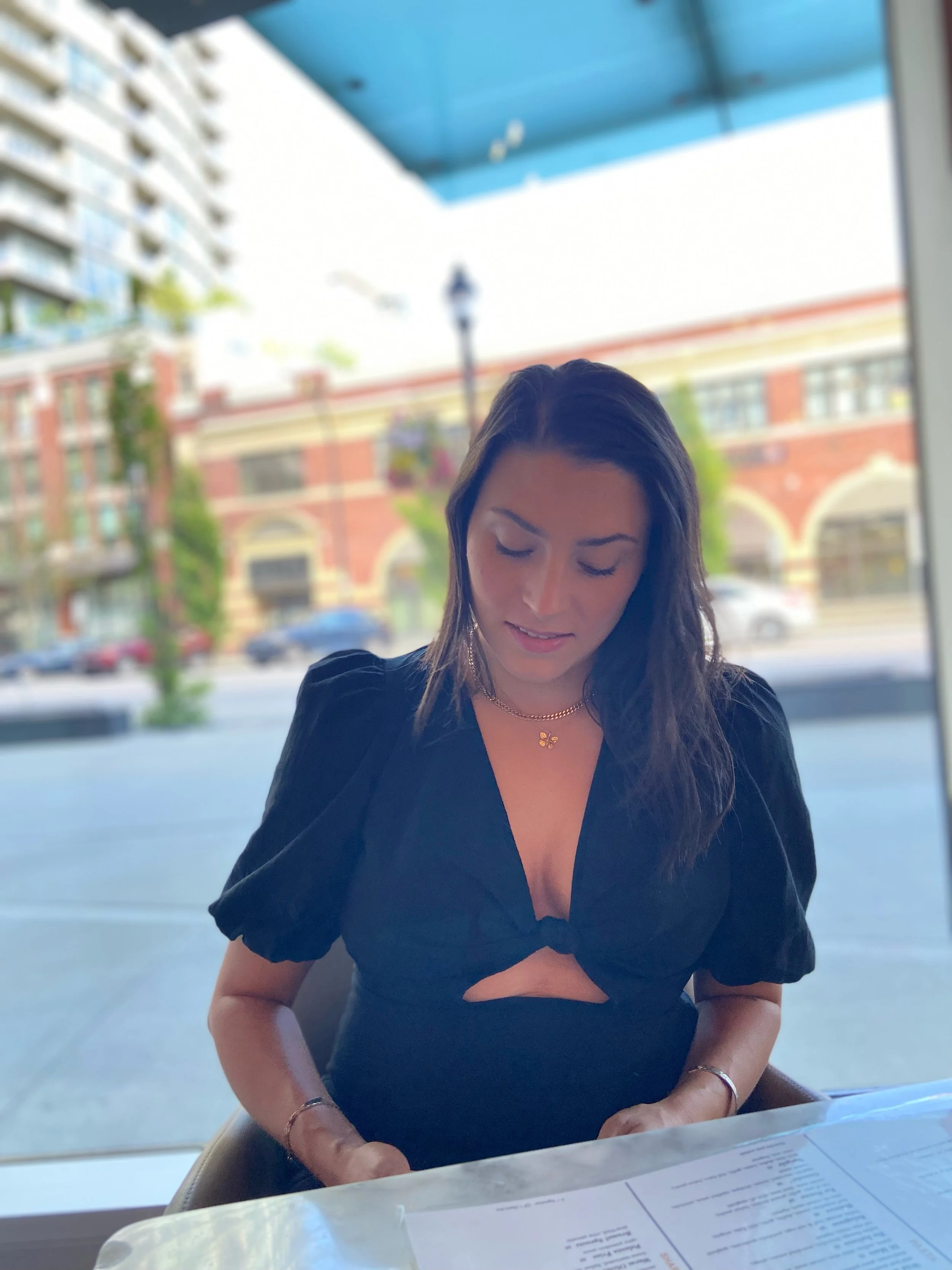 Cynthia Madeleine sitting at a table with a menu.