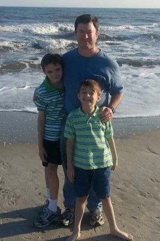 Tom and his two sons standing along Carolina Beach near Wilmington NC.