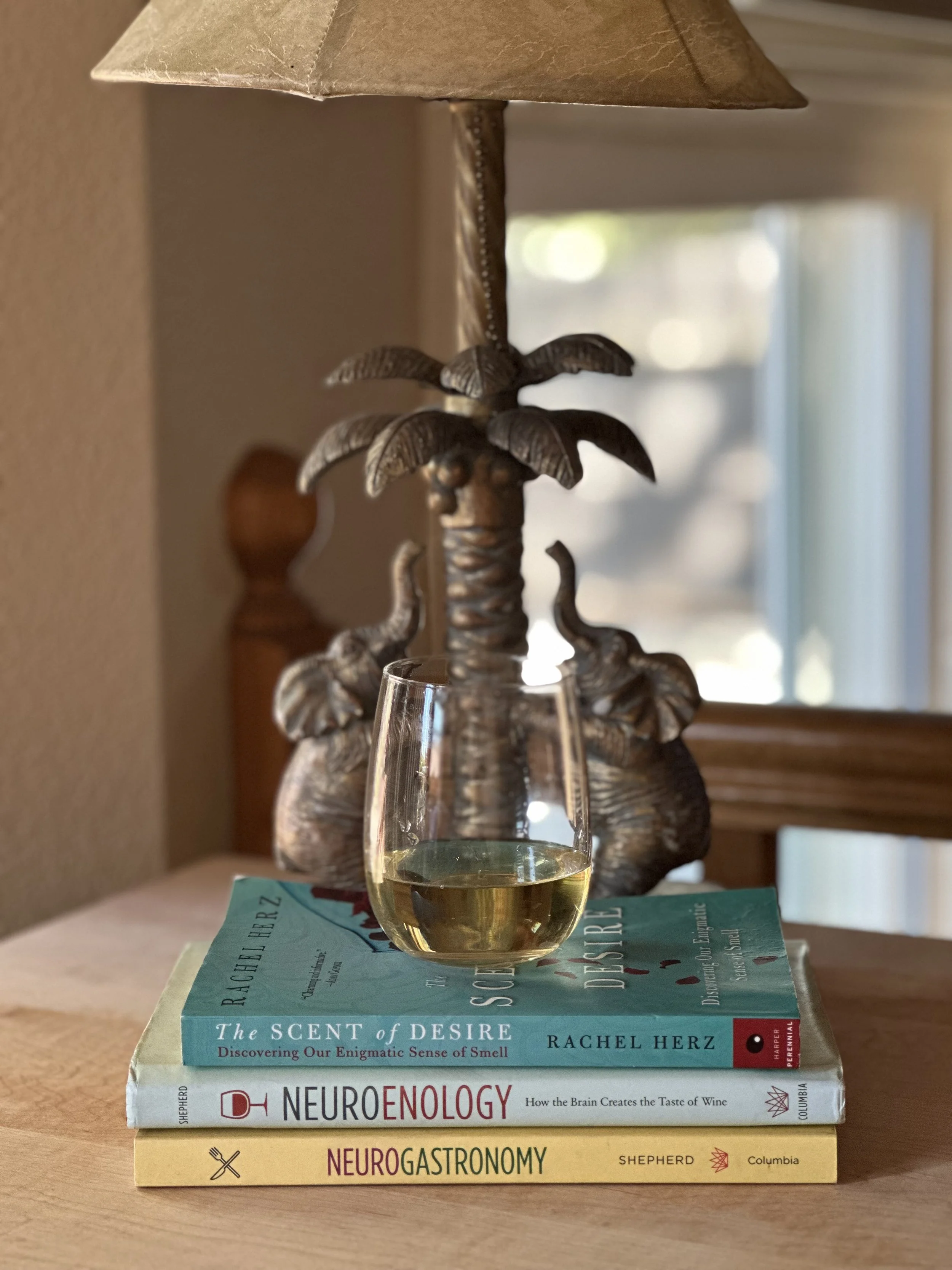 Books on neuroscience with a glass of white wine