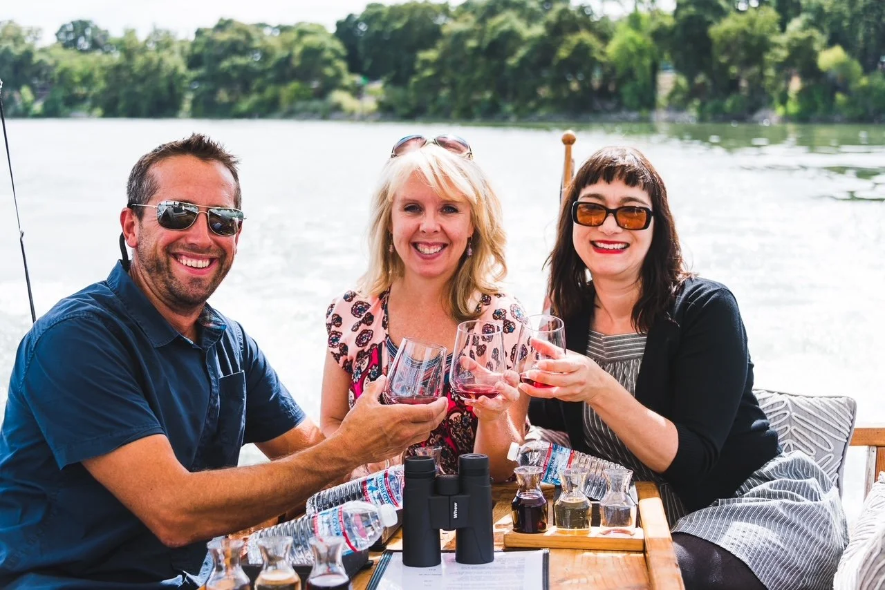 Friends toasting by a lake