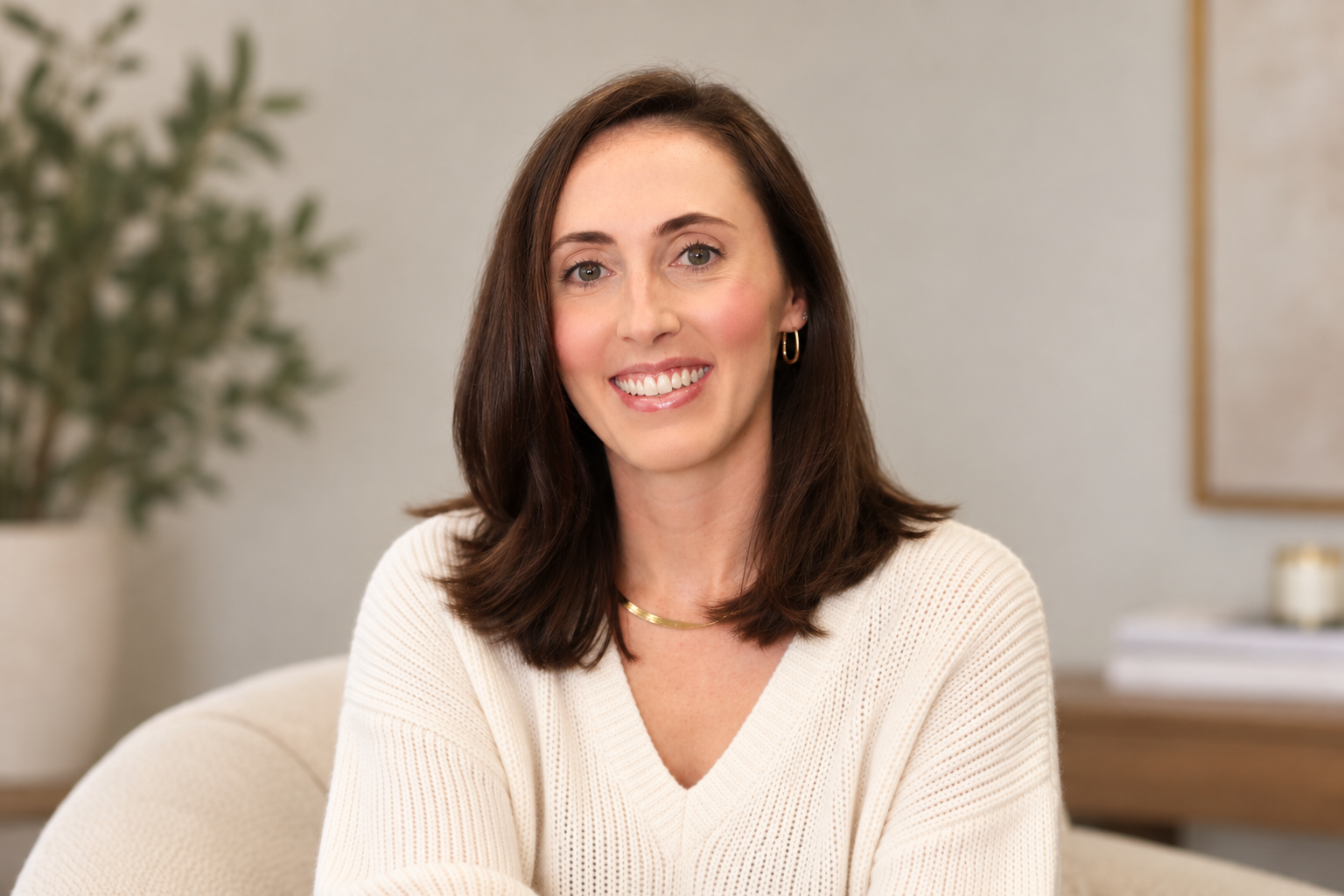 Morgan, founder of Planned Chaos, seated in a chair and smiling