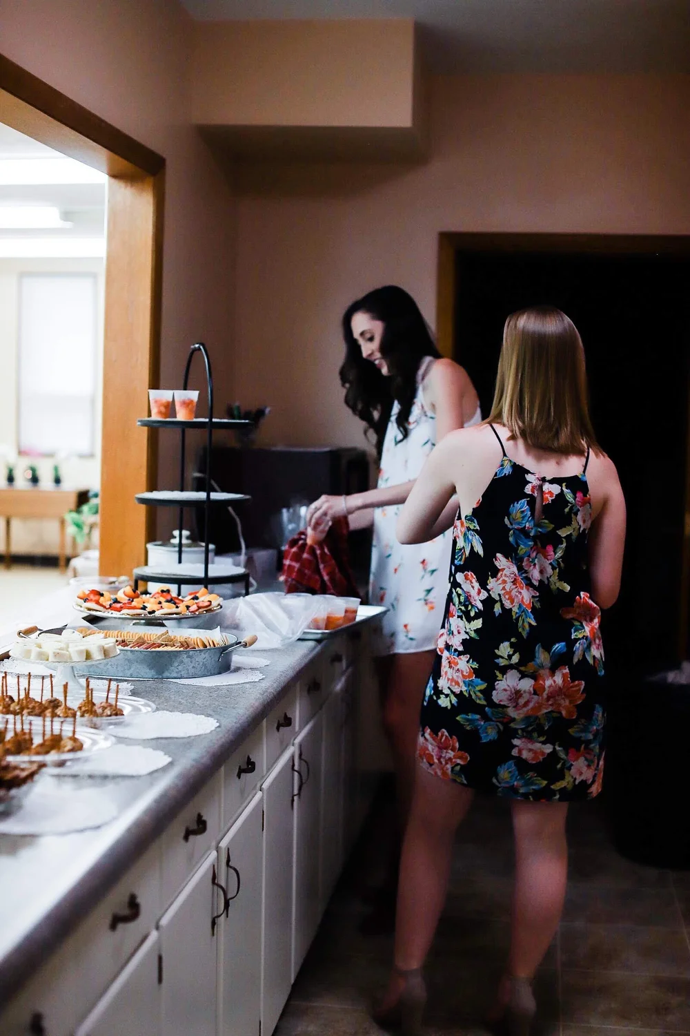 Setting out fruit cups and appetizers on a bridal shower buffet
