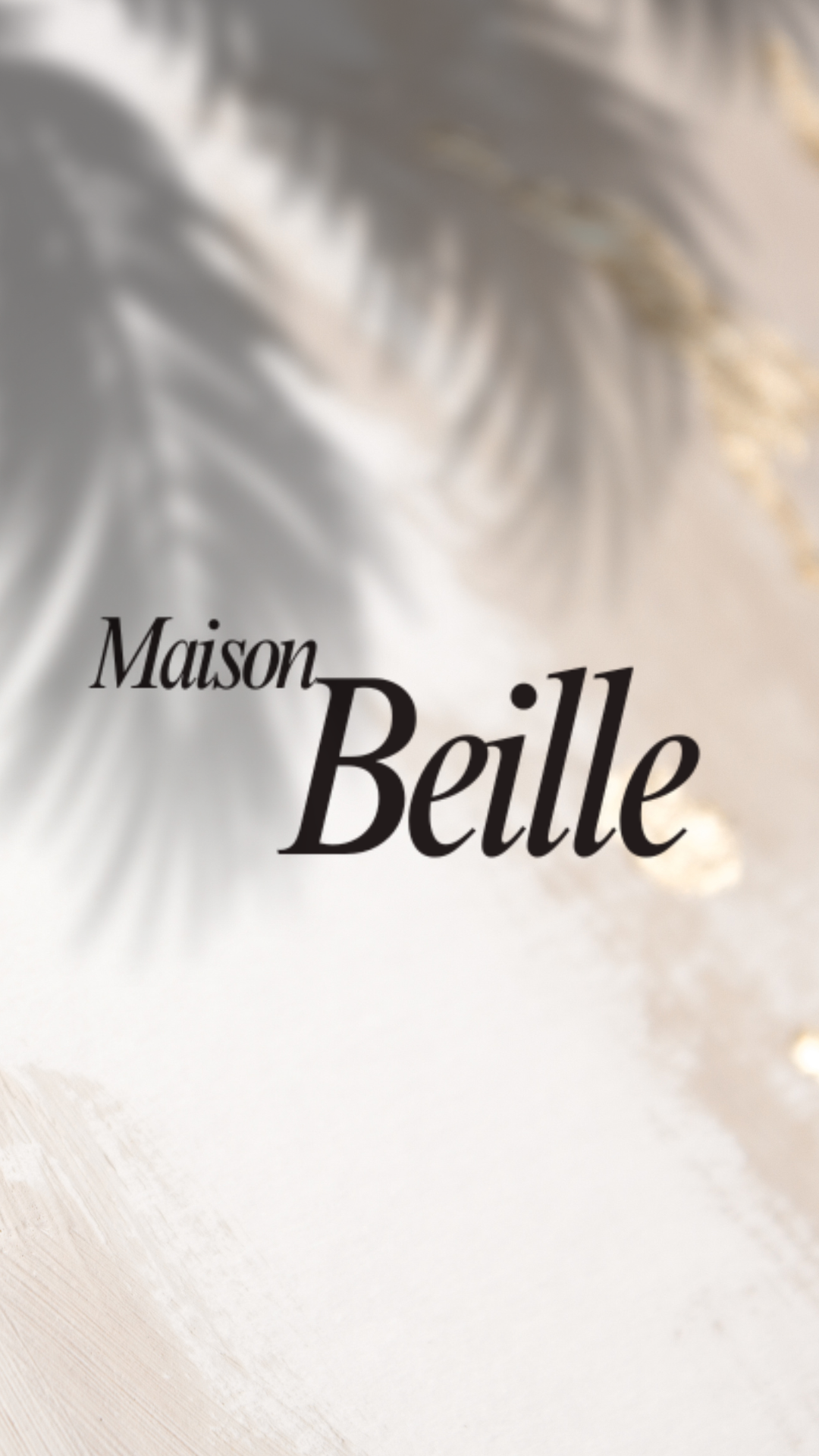 Cover of a magazine or book titled 'Maison Belle' with a soft, abstract, feather-like design in shades of gray, beige, and white.