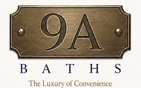 A sign reading '9A BATHS The Luxury of Convenience' with a decorative border and metallic finish.