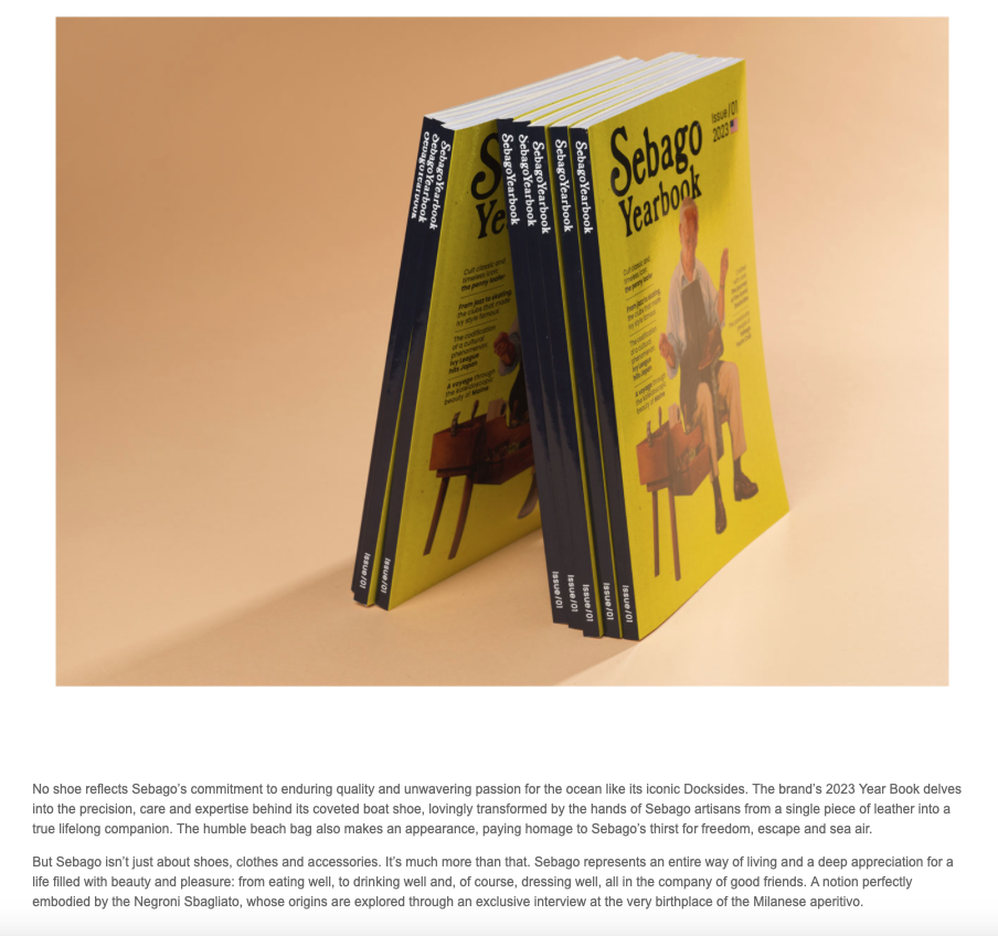 Four yellow and black Sebago Yearbook booklets standing upright on a light peach background.