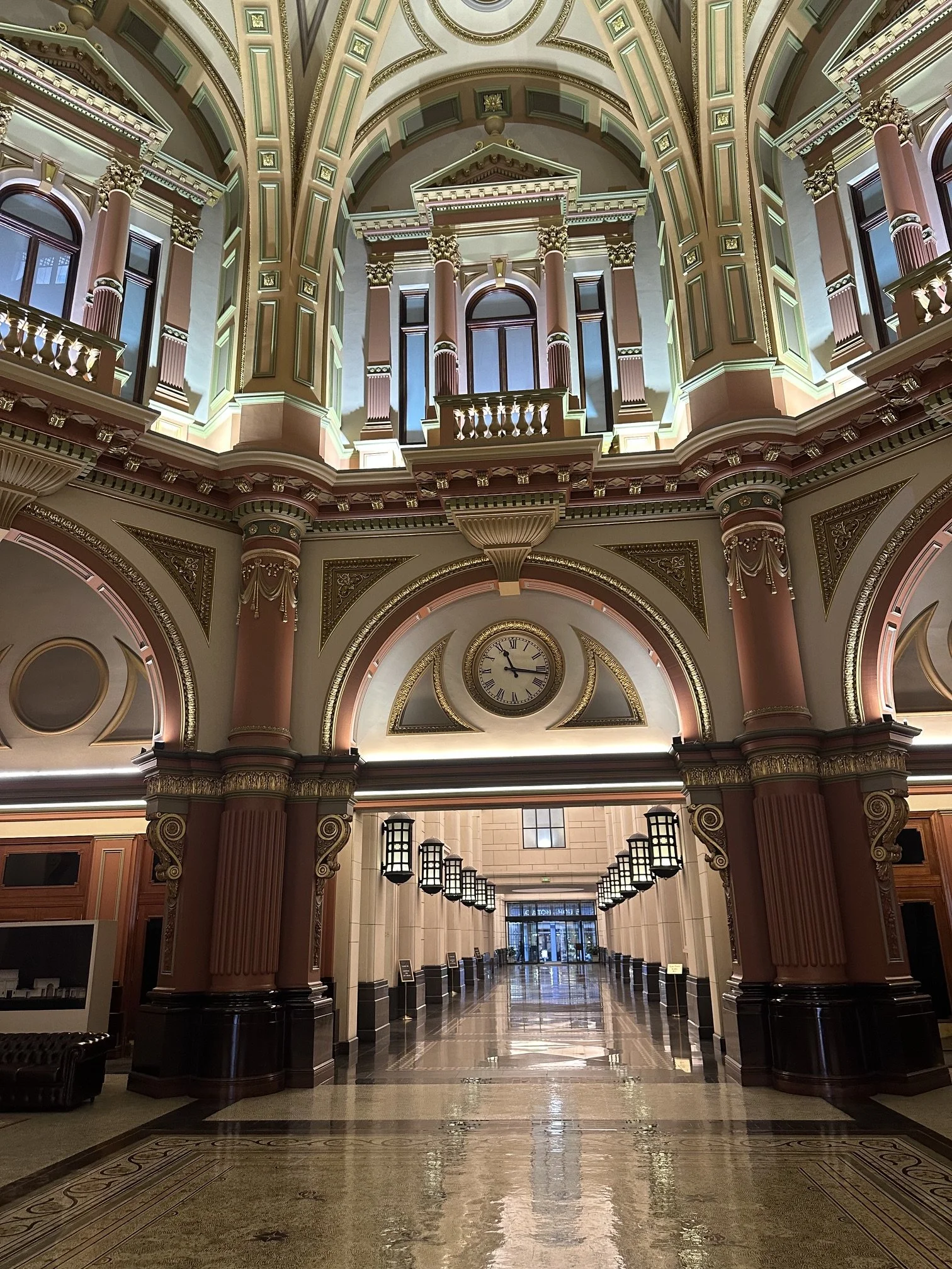 Ornate Melbourne interior with soaring arches, decorative columns and warm golden details.