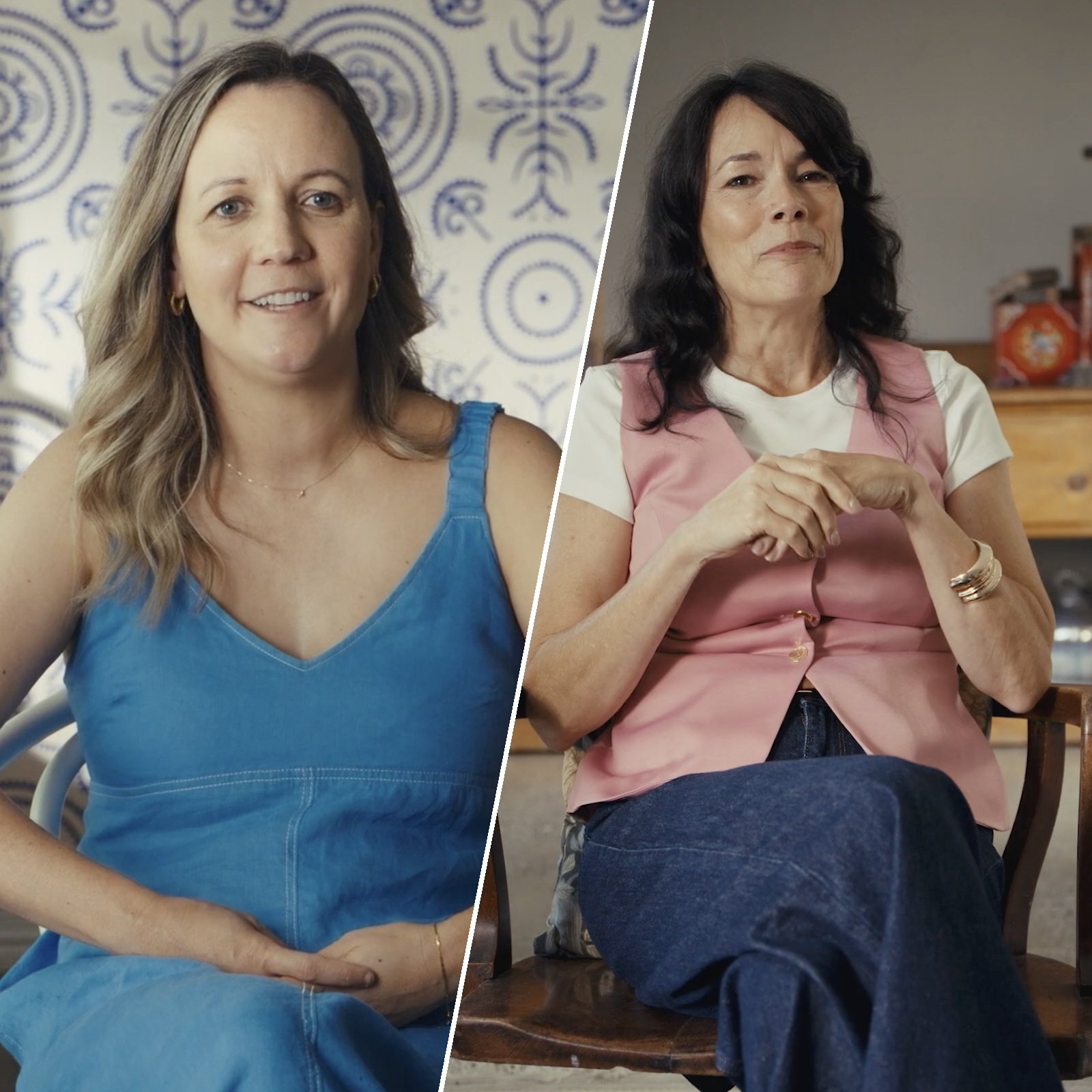 Split image showing two women sitting. The woman on the left has long, wavy light brown hair, wearing a blue sleeveless top, smiling with a background of patterned white and blue. The woman on the right has wavy dark brown or black hair, wearing a pink vest over a white T-shirt, with hands clasped in her lap, in a room with a wooden table and household items in the background.