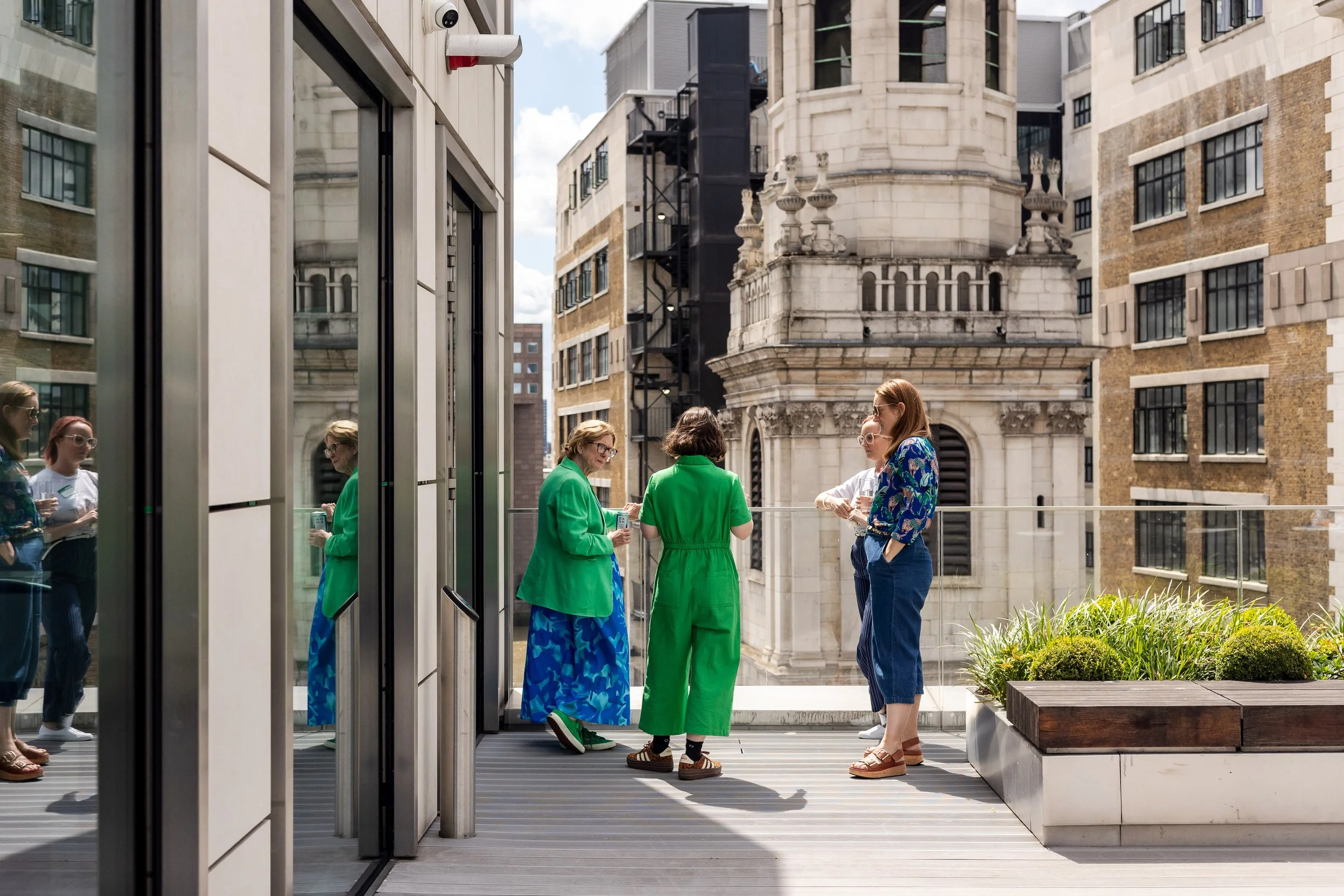 Group in conversation on a bright balcony