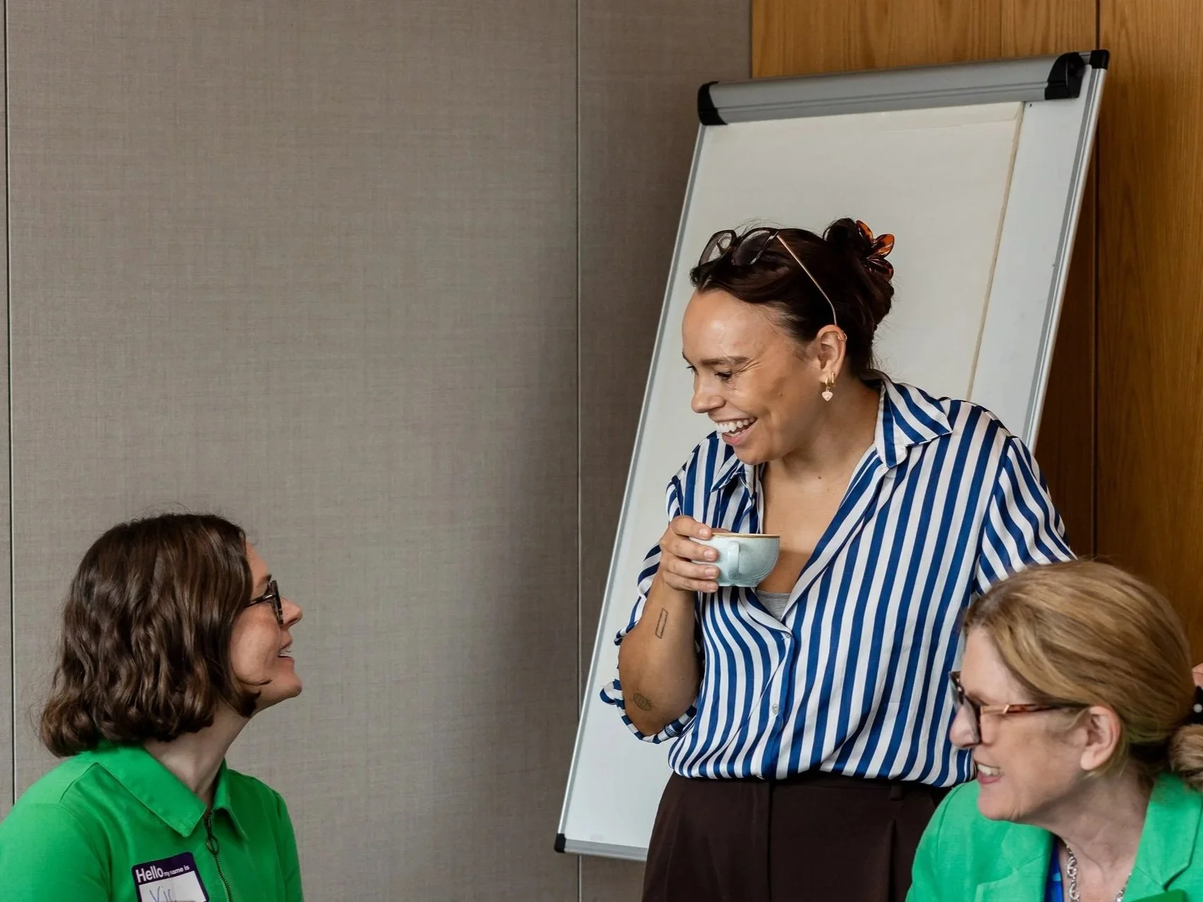 Group of smiling people having coffee in an office