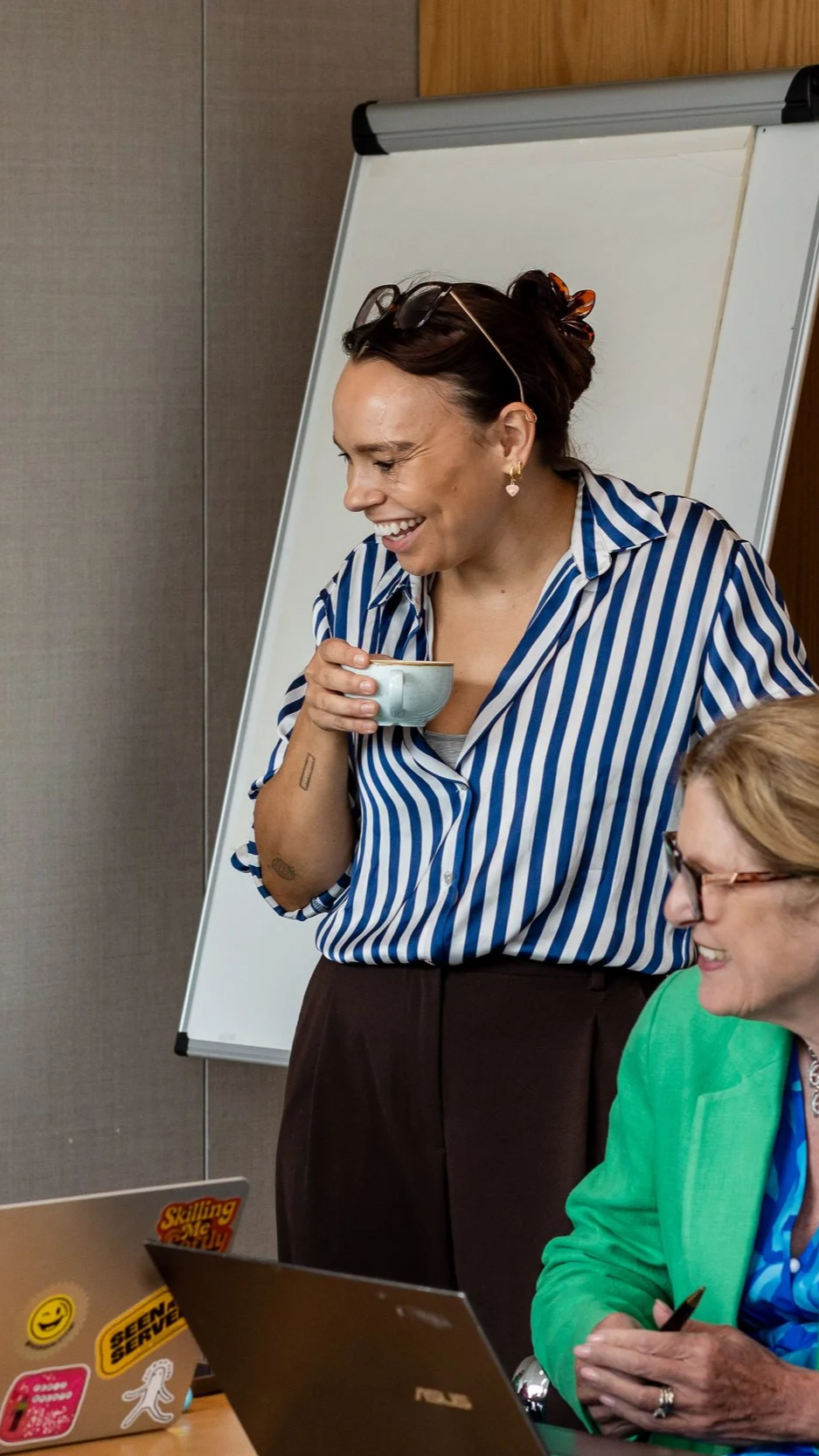 Group of smiling people having coffee in an office