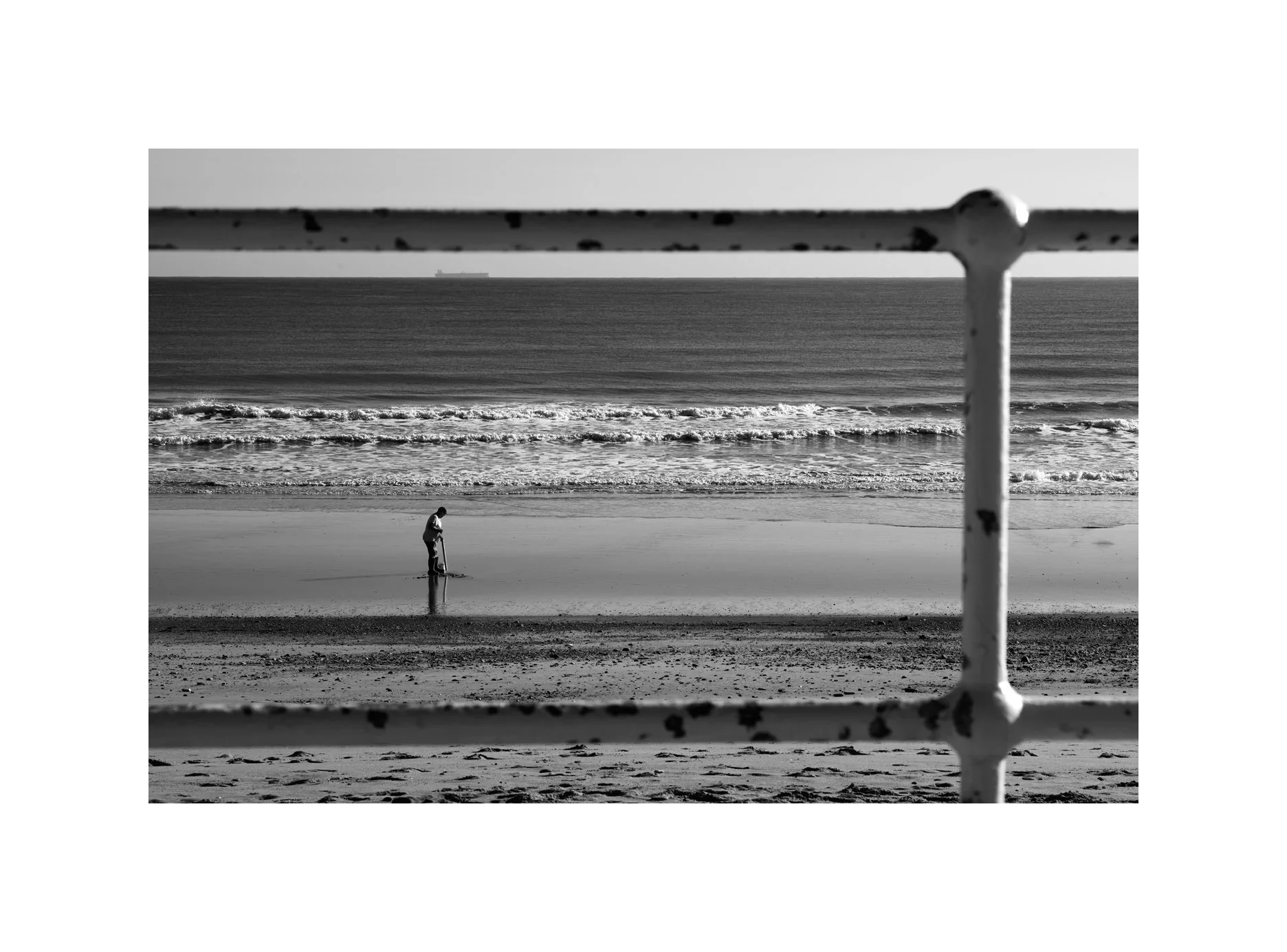 The digger on the Beach and the ship on the Horizon.

#Hornsea 
#Beach 
#Digging 
#Leica 
#BNW