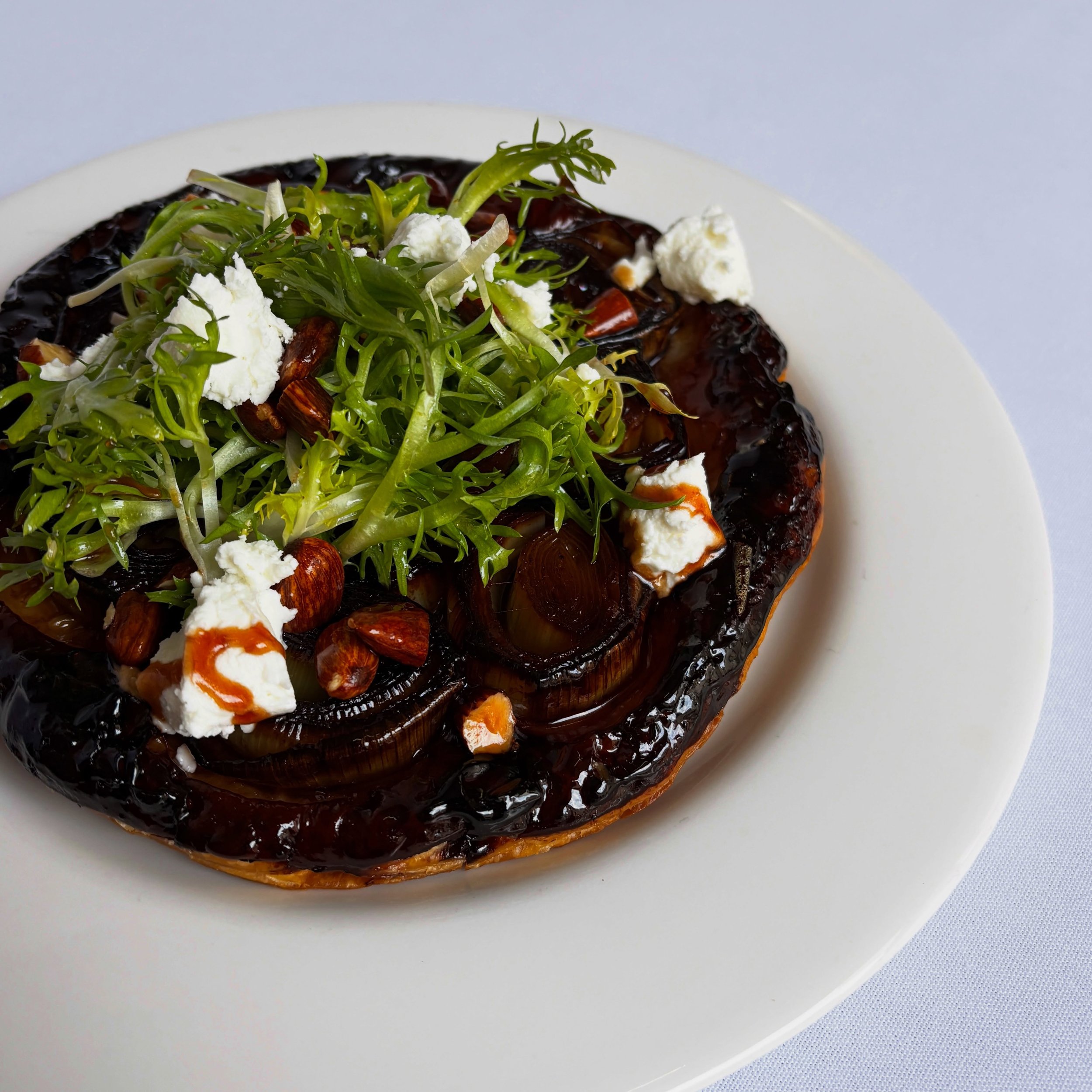~ 𝓟𝓵𝓪𝓽 𝓭𝓾 𝓑𝓪𝓻 ~

Back by popular demand: these flew off the pass a few weeks ago. A tarte tatin of caramelised leeks, crisp pastry, sharp goats curd and a little fris&eacute;e affair.

This week&rsquo;s counter meal in the wine bar: $35 with
