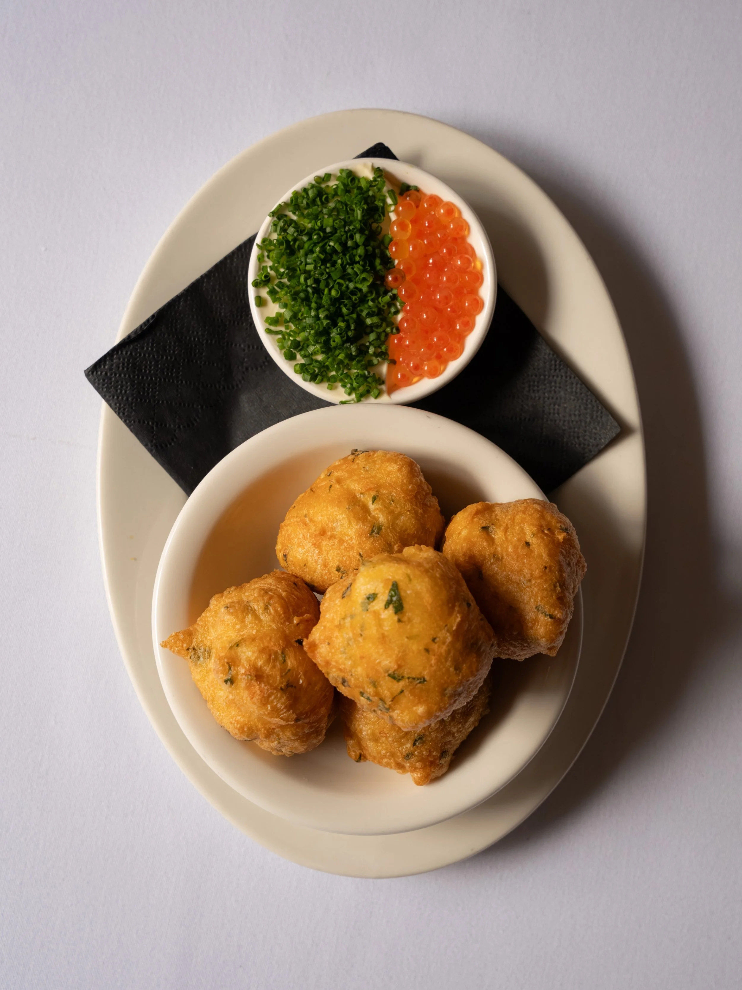 New bar snack: spanner crab beignets with cr&egrave;me fra&icirc;che and salmon roe. Equally good with champagne as they are with a very cold martini

📸 @isabellagwild