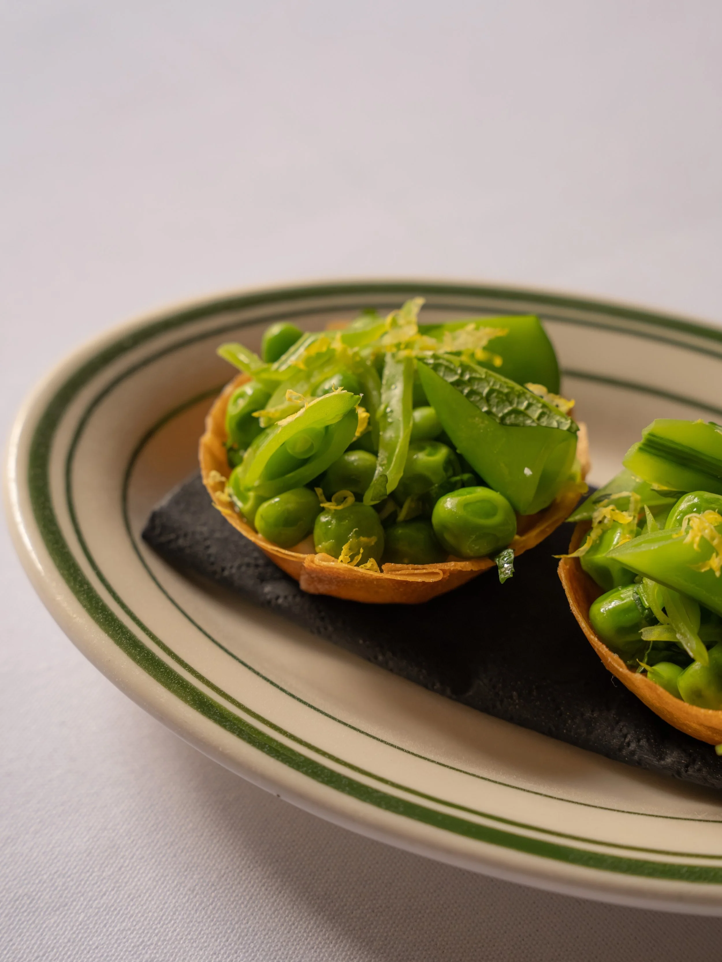 Like our risotto, our tiny little tartlets change with the season to reflect the best that&rsquo;s on offer. Currently filled with tangy goat&rsquo;s cheese, freshly shelled baby peas, mint &amp; sugarsnaps, these are the perfect little crispy mouthf