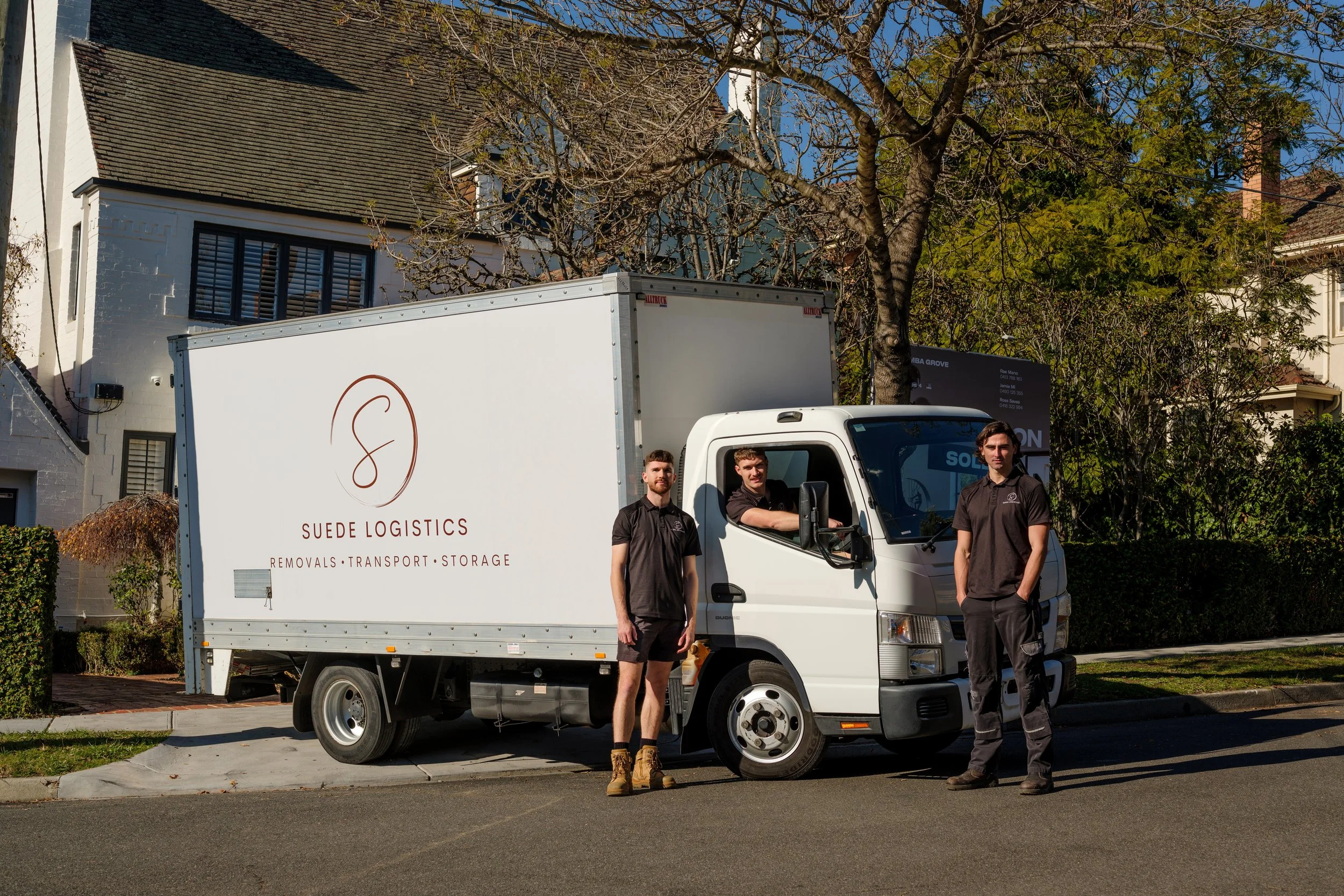Suede Logistics team standing in front of their removals truck in Melbourne