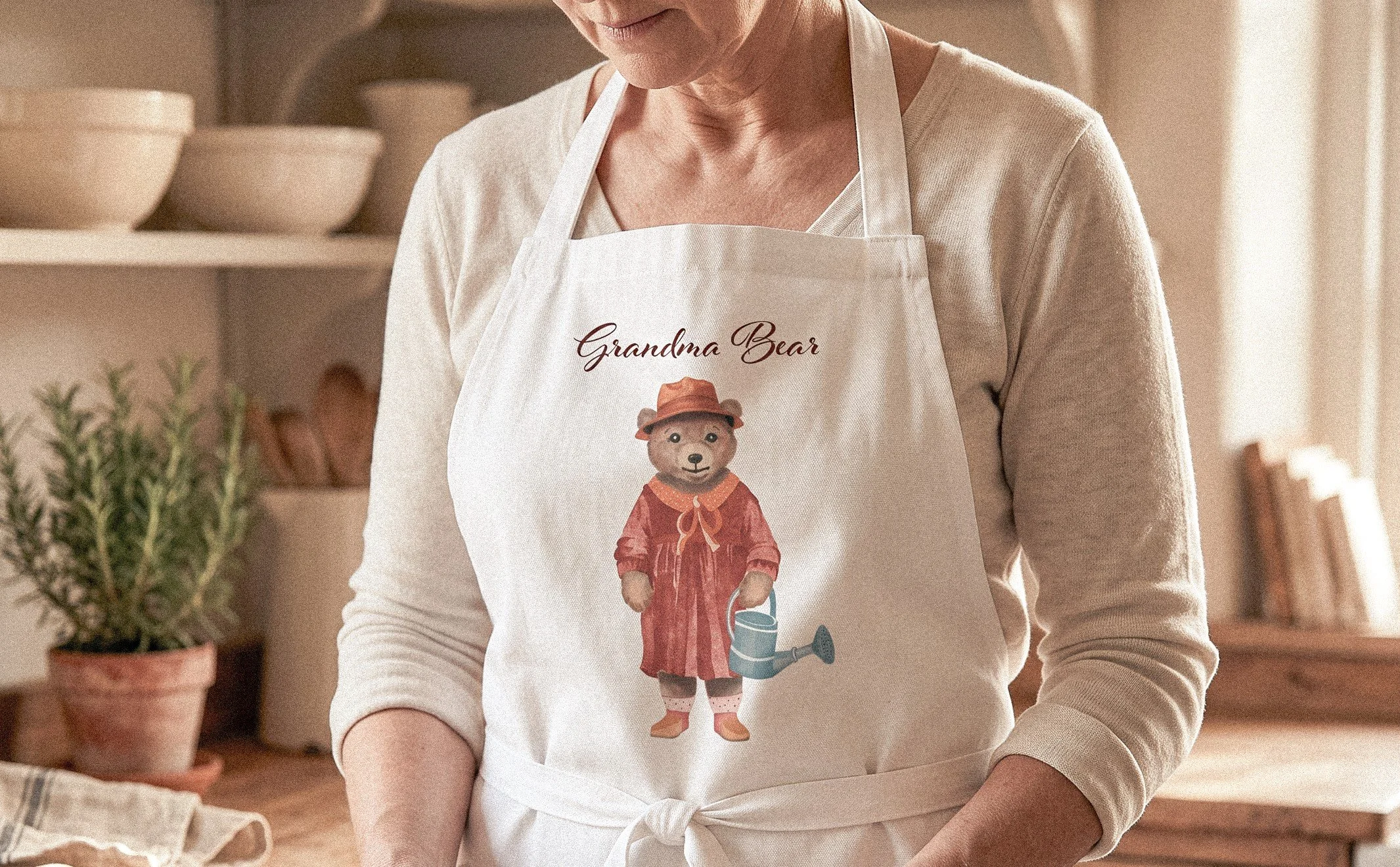 Artlen Studio Grandma Bear apron featuring an original illustrated bear design, styled in a warm kitchen.