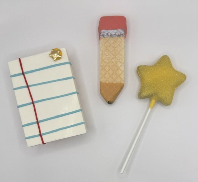 School-themed chocolate-dipped treats featuring a Rice Krispies treat, pencil-shaped wafer, and gold chocolate star.