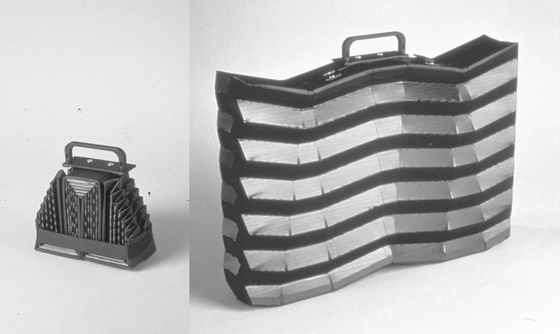 Two stacked vegetable grater slicers, one small and one large, shown in black and white.