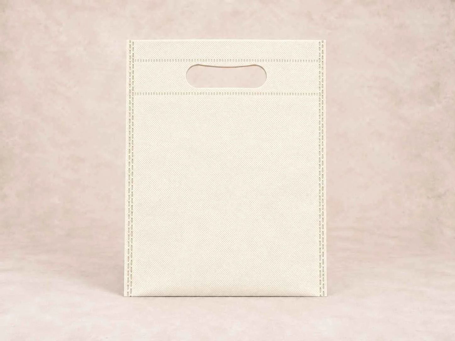 Bolsa de cambrel reutilizable plana troquelada color hueso sobre un fondo neutro.