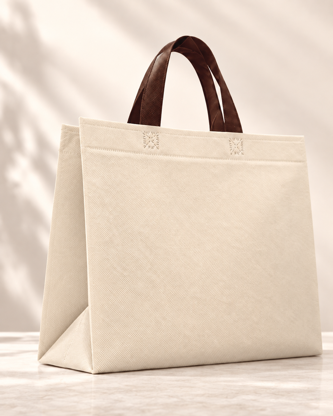 Bolsa 3 fuelles de cambrel reutilizable color márfil con manijas café sobre un fondo neutro.
