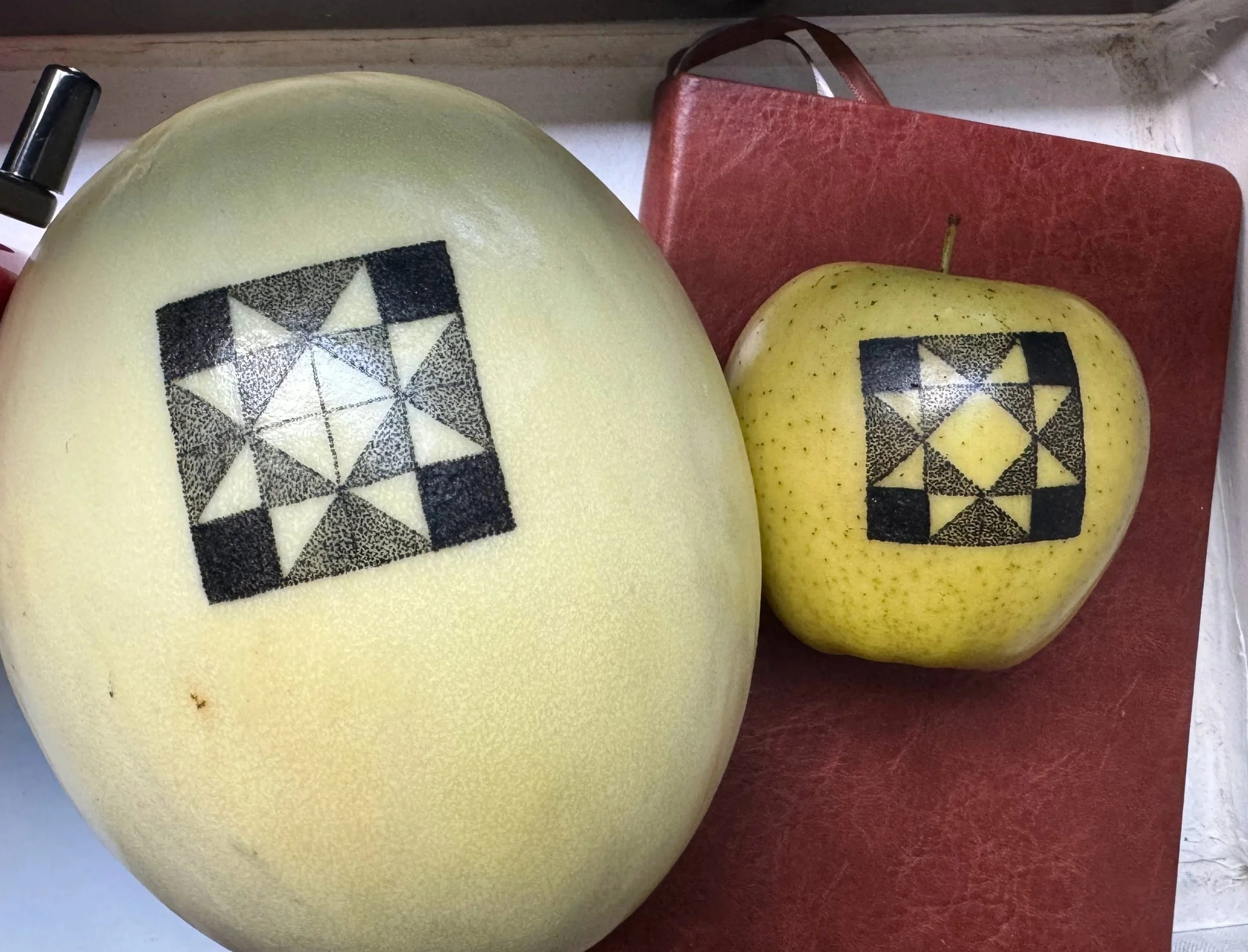 Hand poke on melon and apple