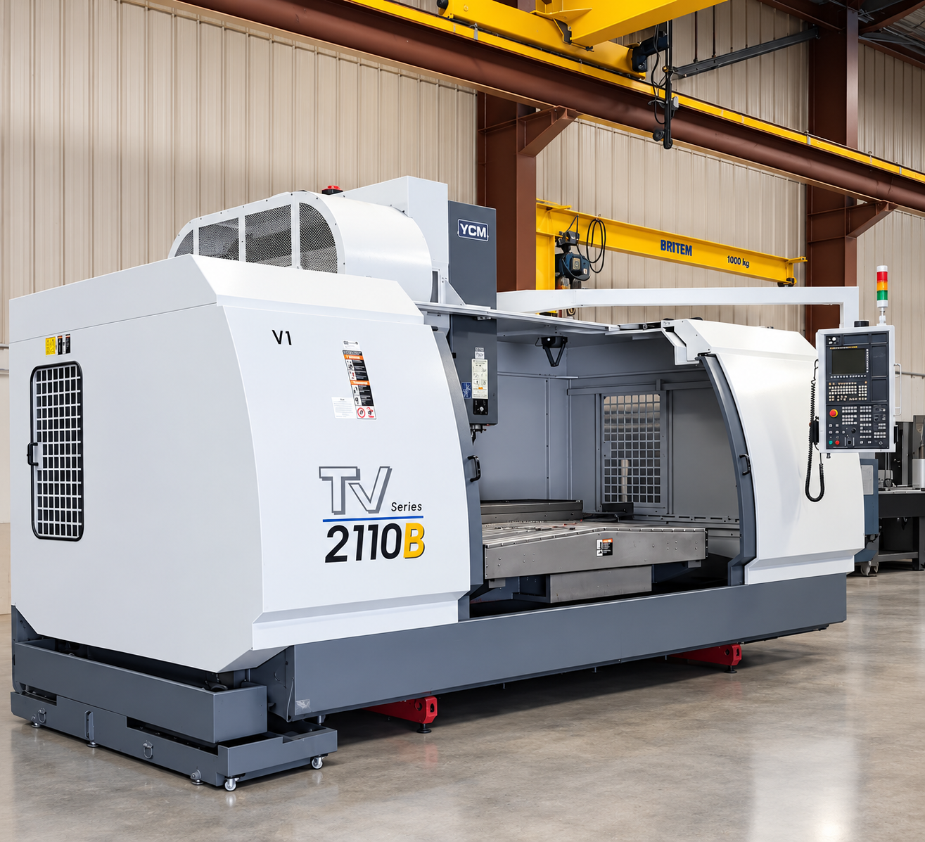 Industrial CNC machine in a factory setting, with control panel and safety guard.