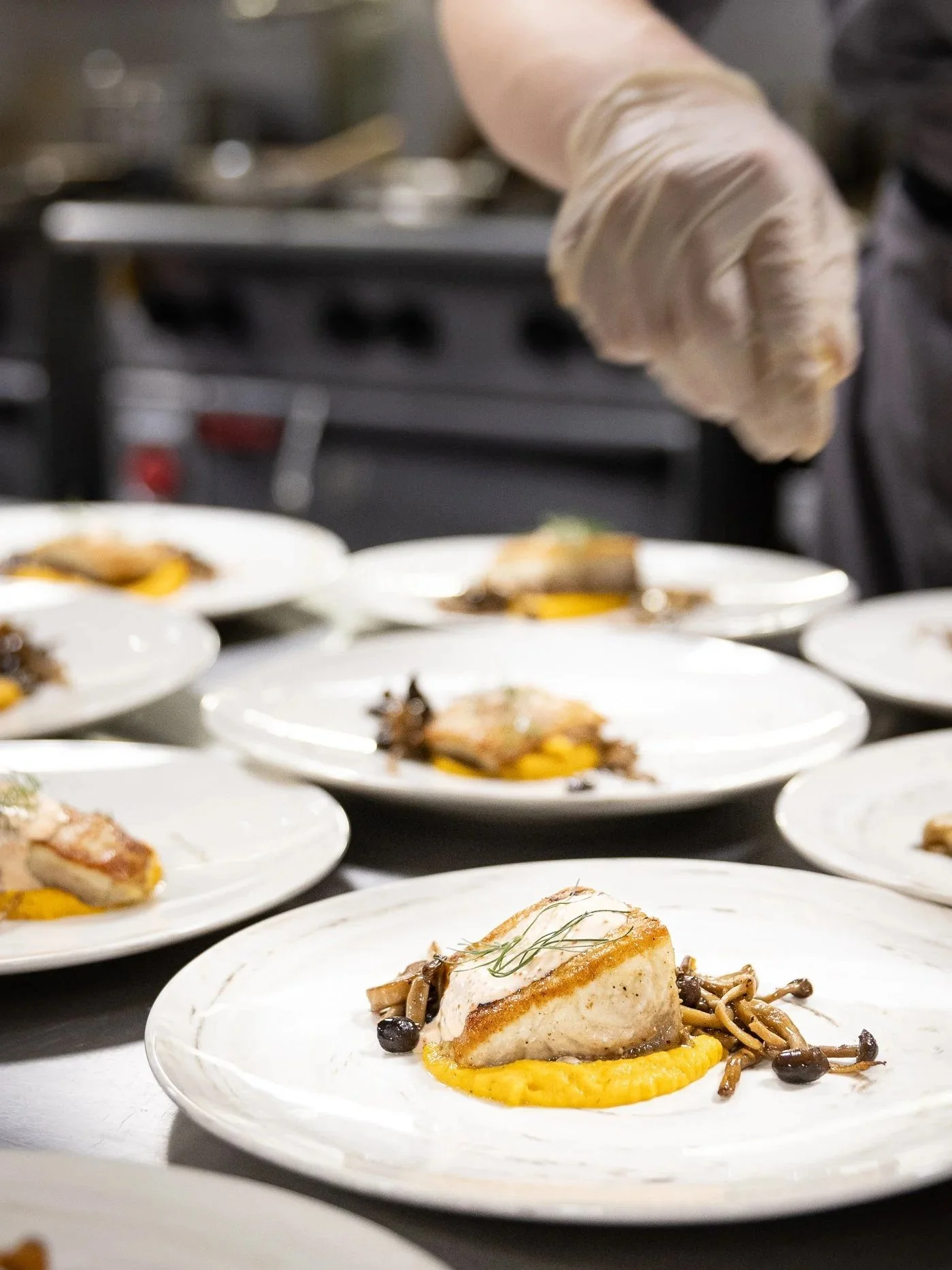 Student Plating Entrees on the line at Broadmoor Bistro