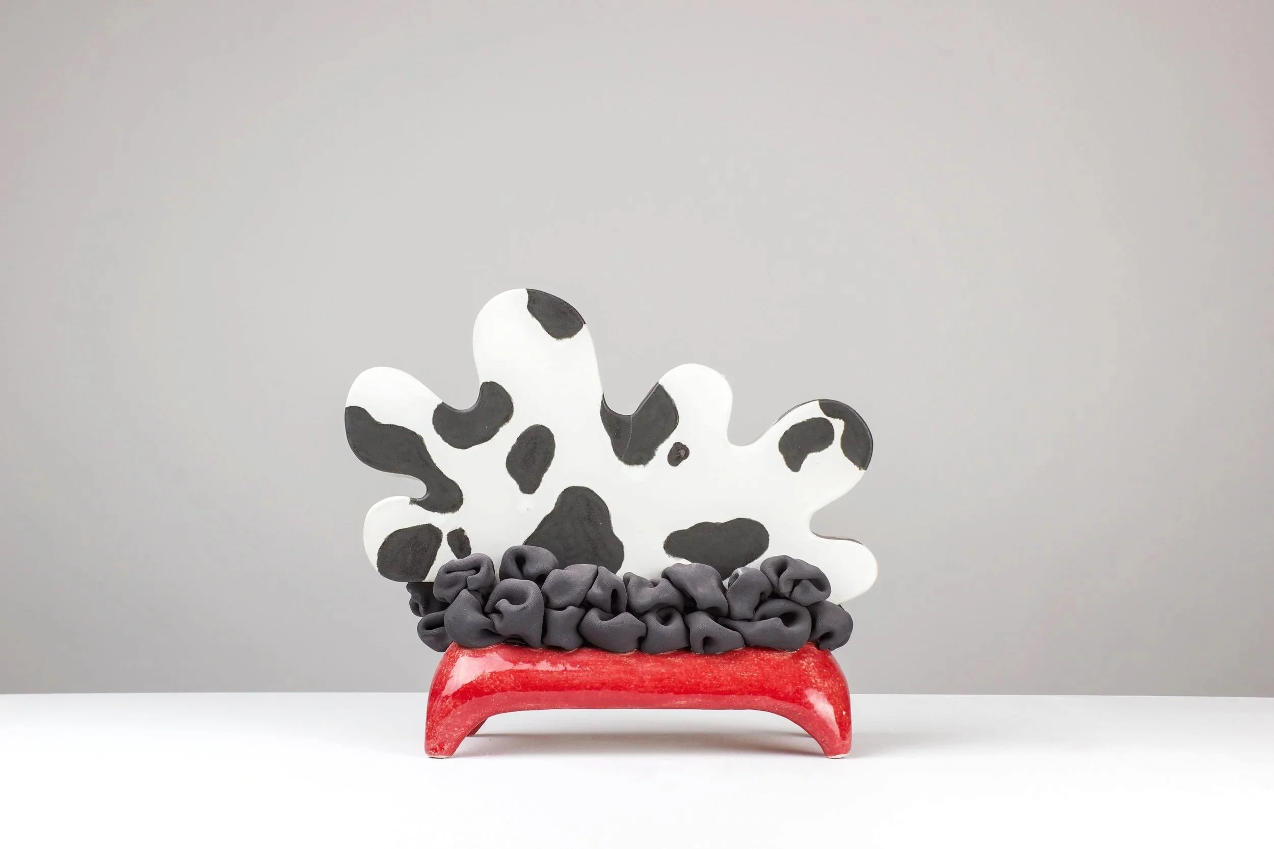 Resting cow, 2025. White clay, engobe, glaze. 32x37x15cm