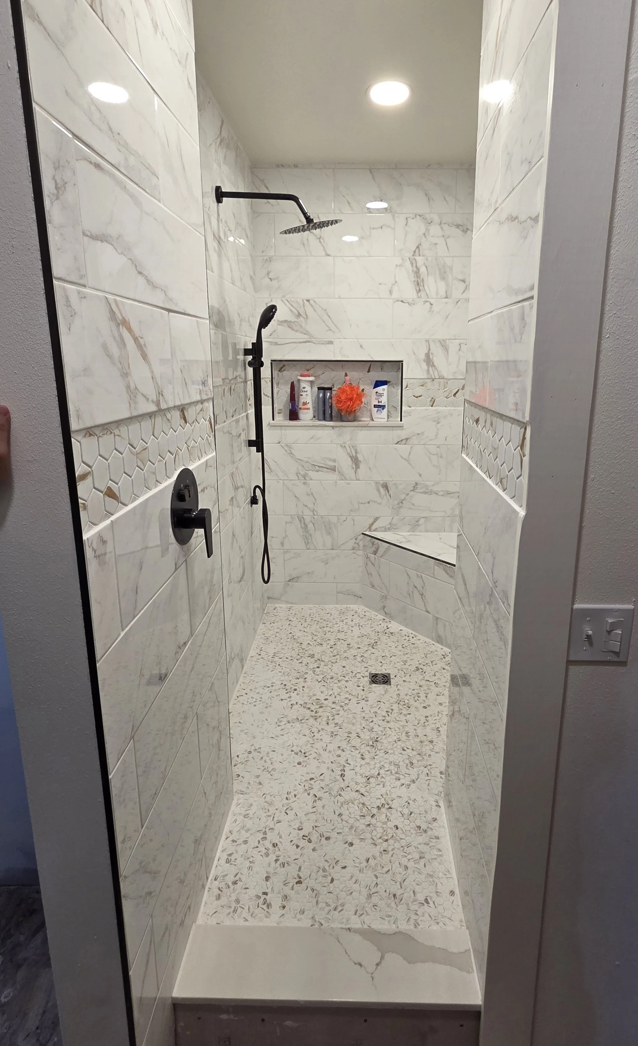 	
Custom bathroom remodel with glass shower, white marble tile, and built-in niche in Logan, Utah
