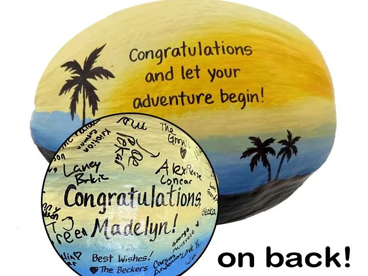 Blue and yellow sunset graduation coconut with signatures on back