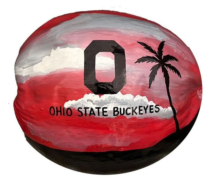 Hand-painted coconut shell features the iconic Ohio State Buckeye logo. An unique canvas for the vibrant college colors to celebrate your pride. Customize with your favorite team.