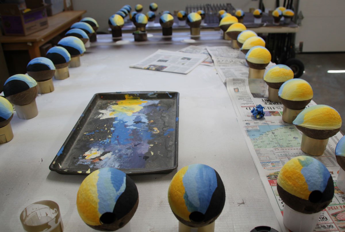 Large production of hand painted coconut wedding invitations