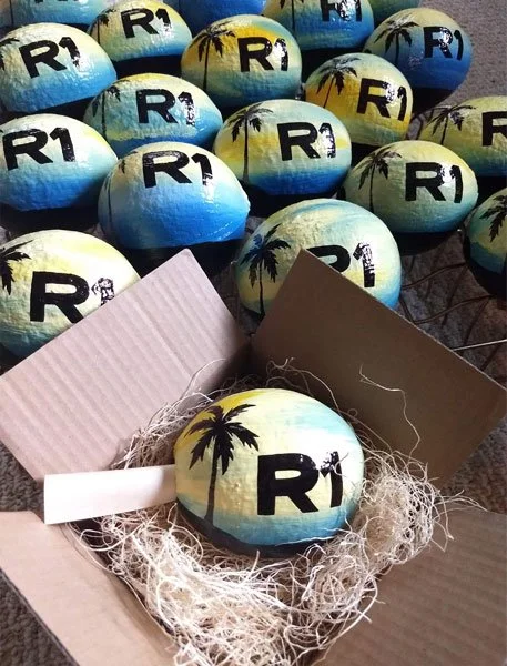 Logo branding with painted hollow coconuts. Scroll added with additional verbiage. Long-lasting, green and eco-friendly gifts.