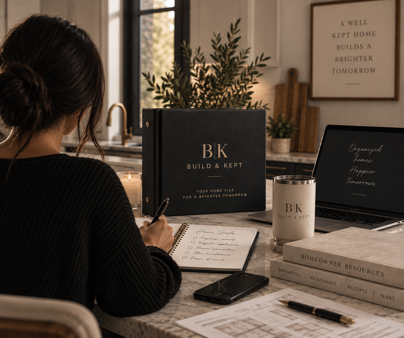 A woman organizing homeowner records with a Build & Kept home management binder.