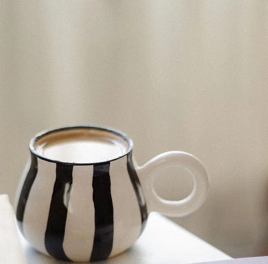 Ceramic coffee mug on a table.