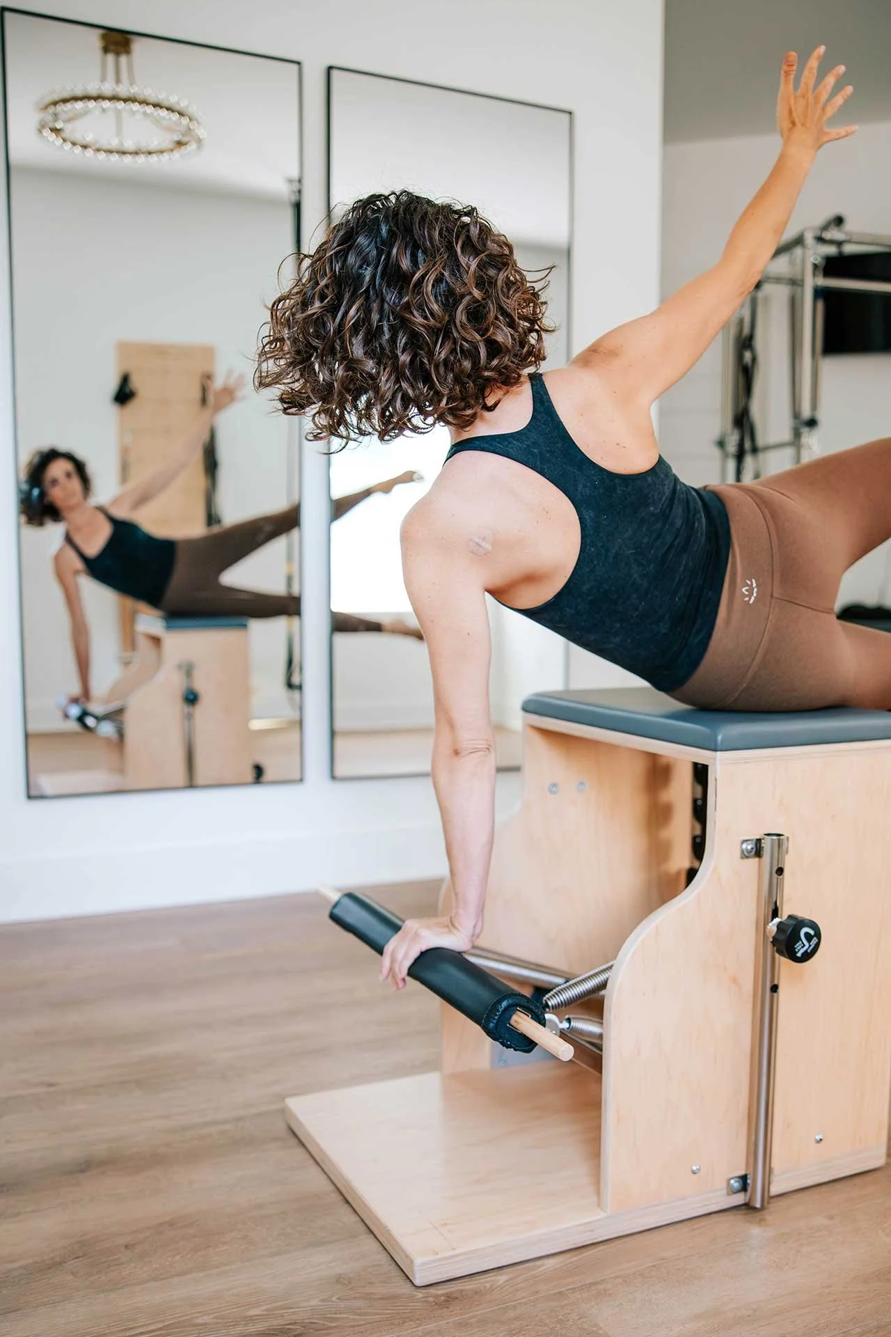 Pilates instructor Kim Russell demonstrating an exercise on a reformer