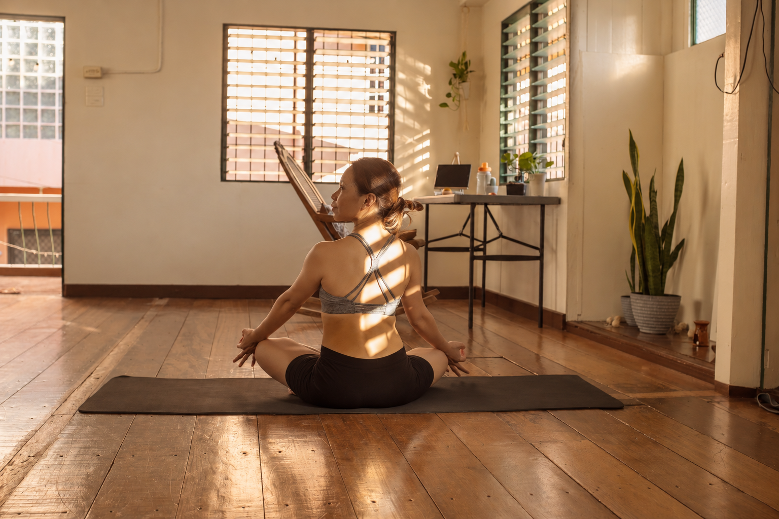 Woman doing Mat Pilates at home on a mat