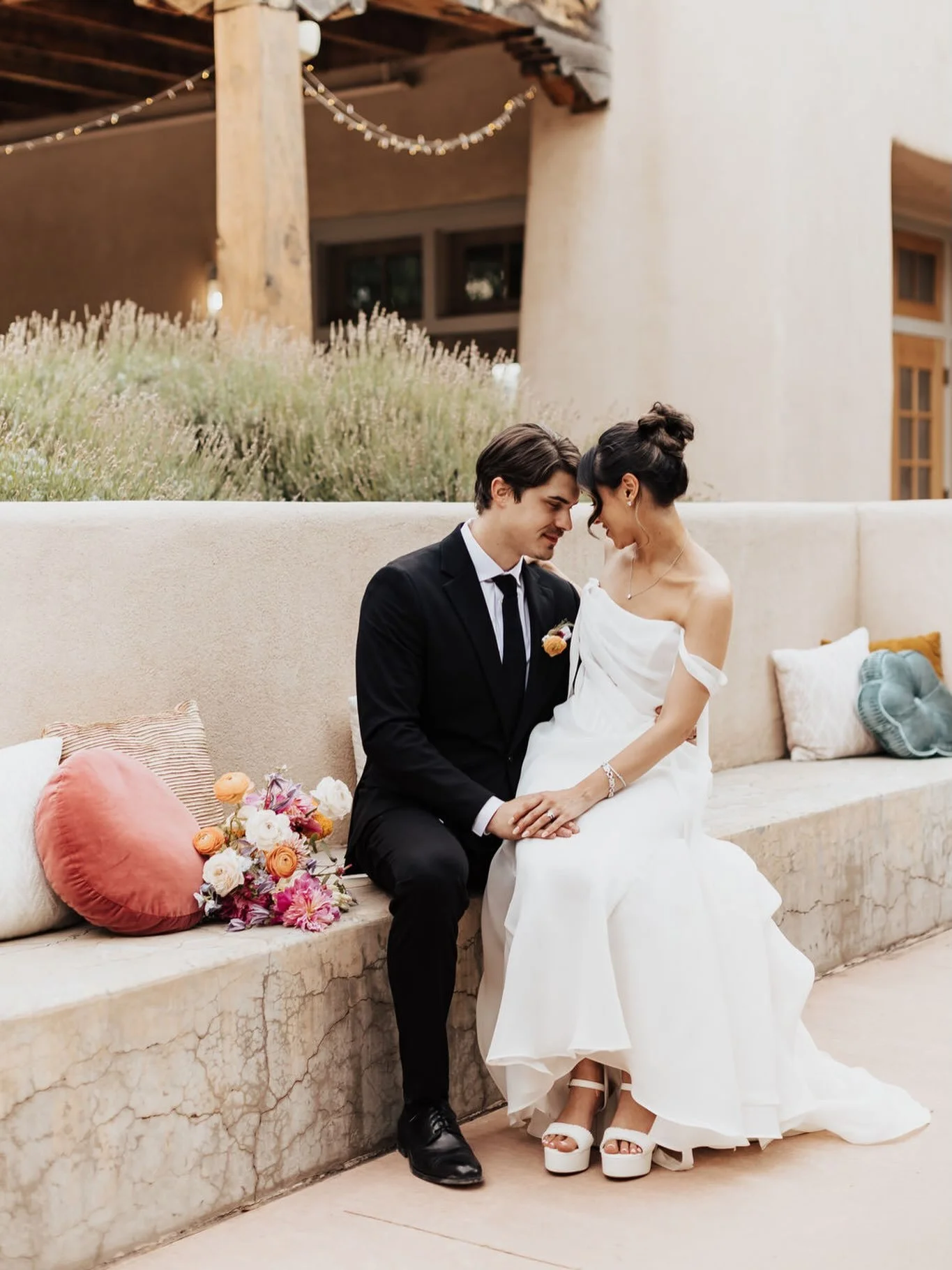 One of our favorite styling hacks is using pillows, throws, and poufs on built in or existing furniture at your venue! This is a great way to tie your wedding colors and theme into the event space, making everything feel curated and intentional for y