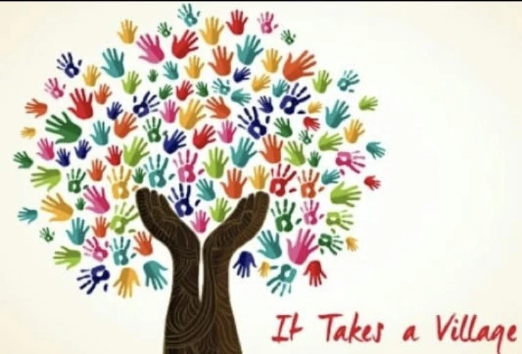 Colorful handprints arranged to form a tree with a brown trunk, and the phrase "It Takes a Village" written in red in the bottom right corner.