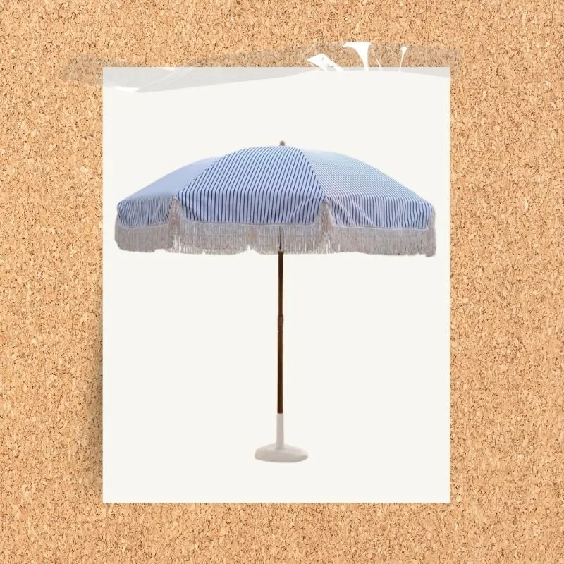 Blue and white striped outdoor parasol with fringe