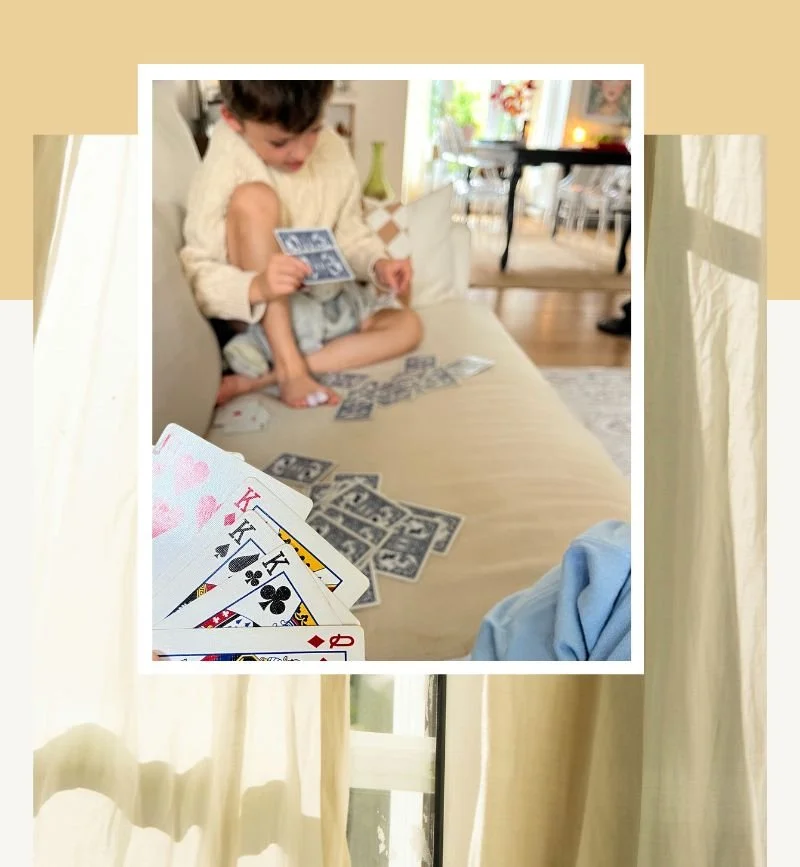 A cozy family card game at home in soft afternoon light.