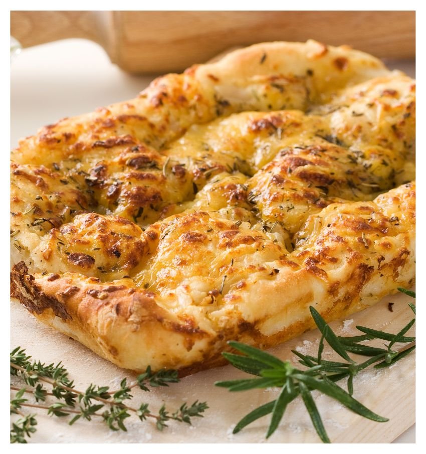 Close-up of homemade cheesy herb focaccia with a golden baked crust.